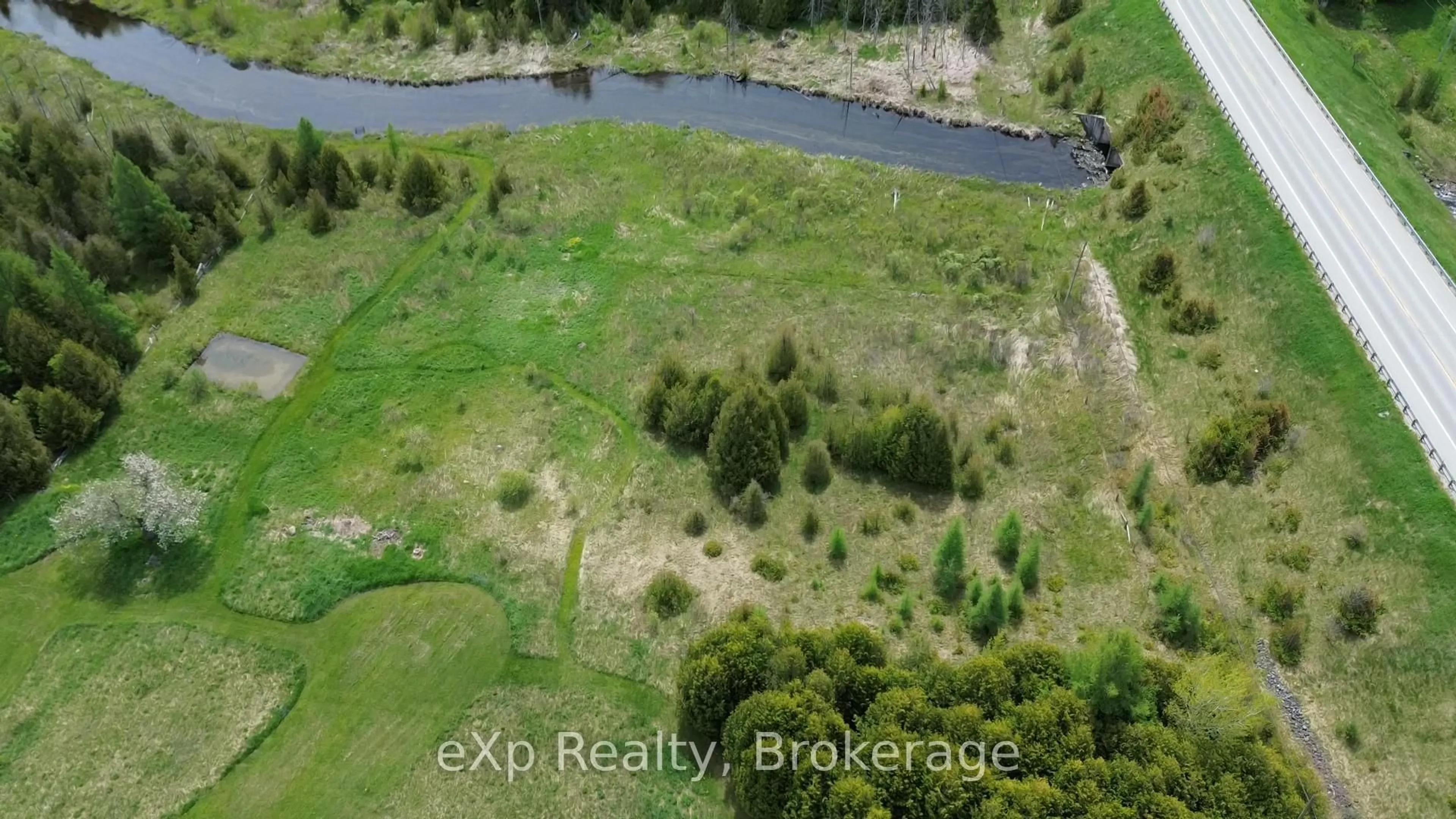 A pic from outside/outdoor area/front of a property/back of a property/a pic from drone, water/lake/river/ocean view for 775355 10 Highway, Grey Highlands Ontario N0C 1H0