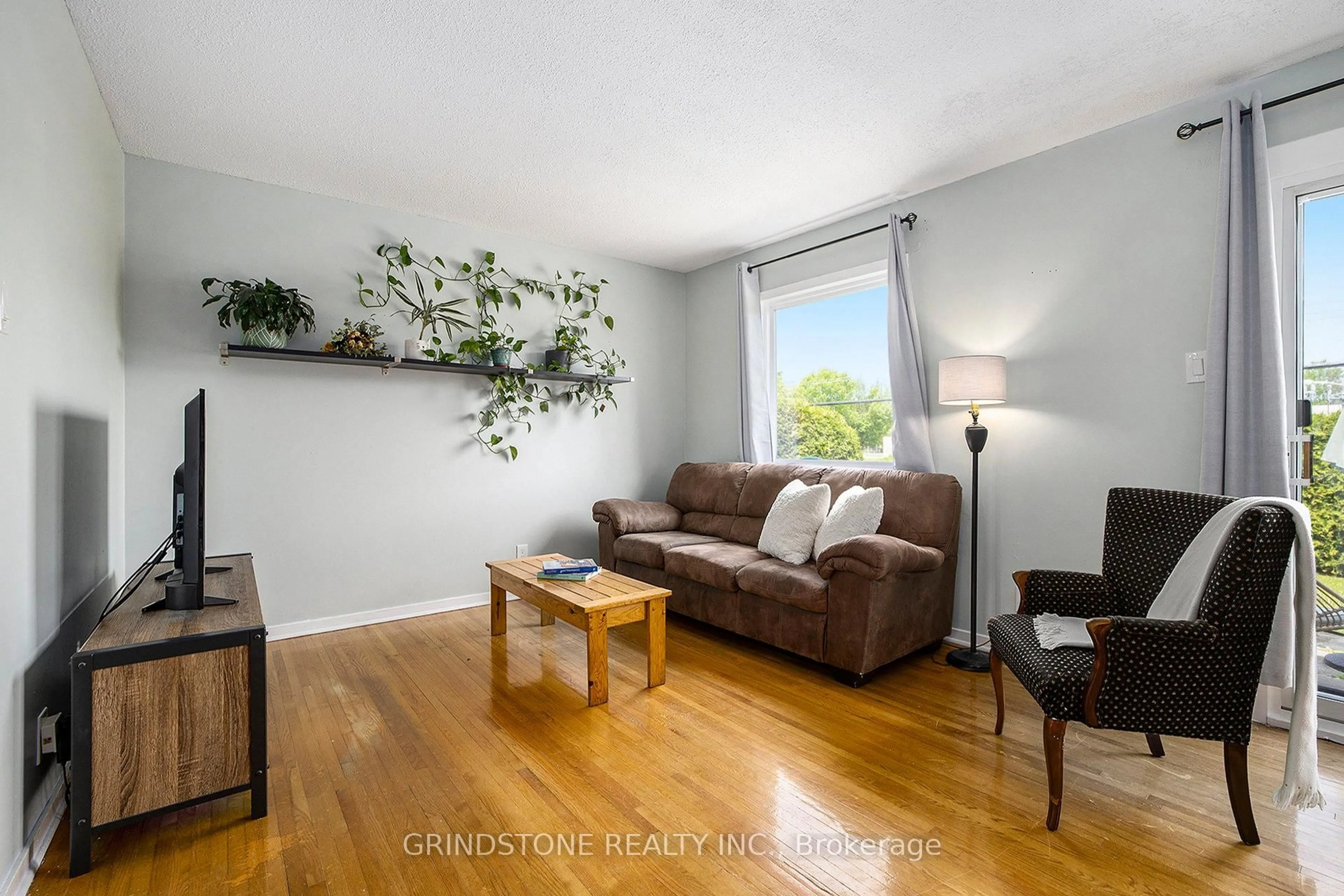 Living room with furniture, wood/laminate floor for 3920 Old Richmond Rd #D, Ottawa Ontario K2H 5C6