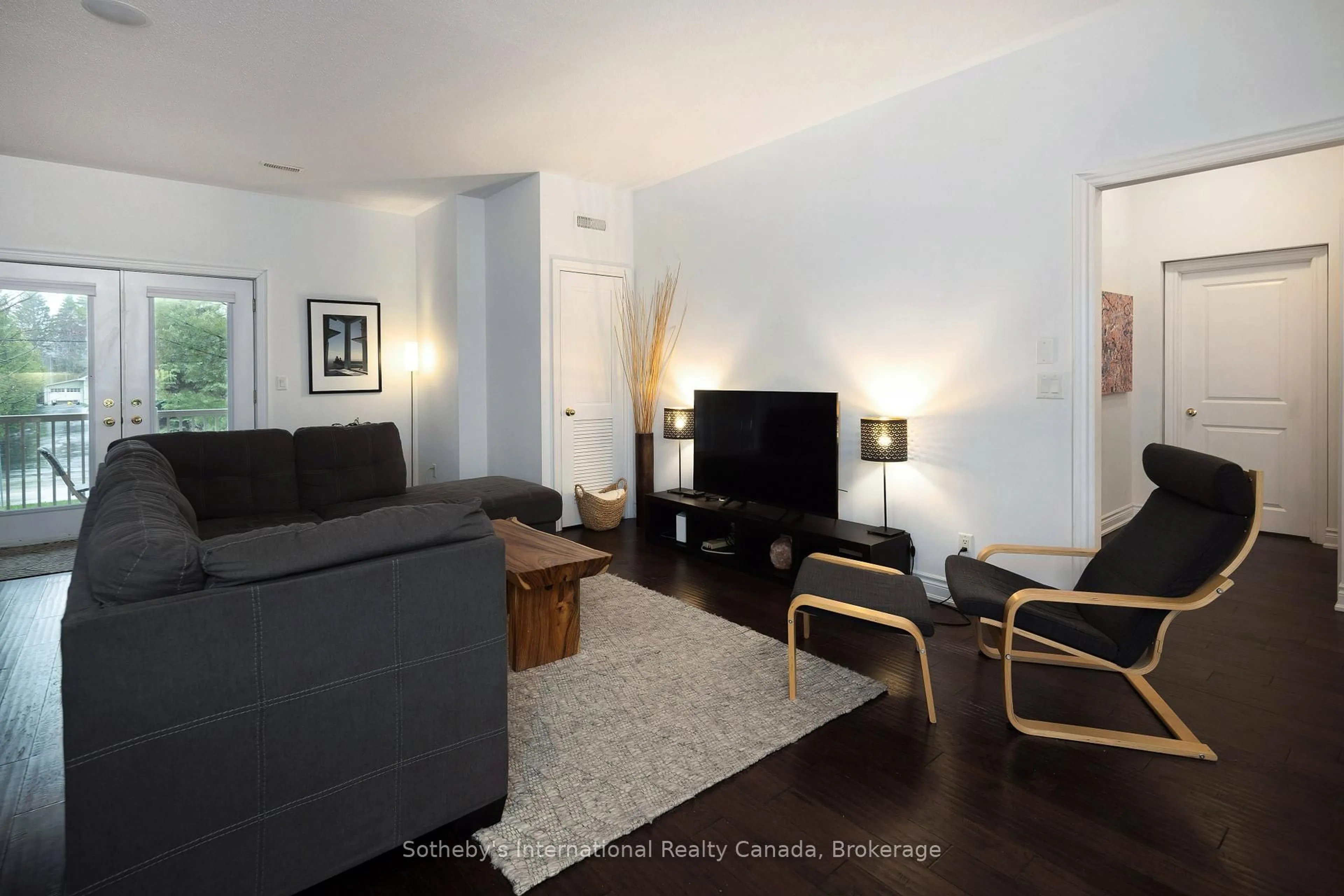 Living room with furniture, wood/laminate floor for 25 Beaver St #107, Blue Mountains Ontario N0H 2P0