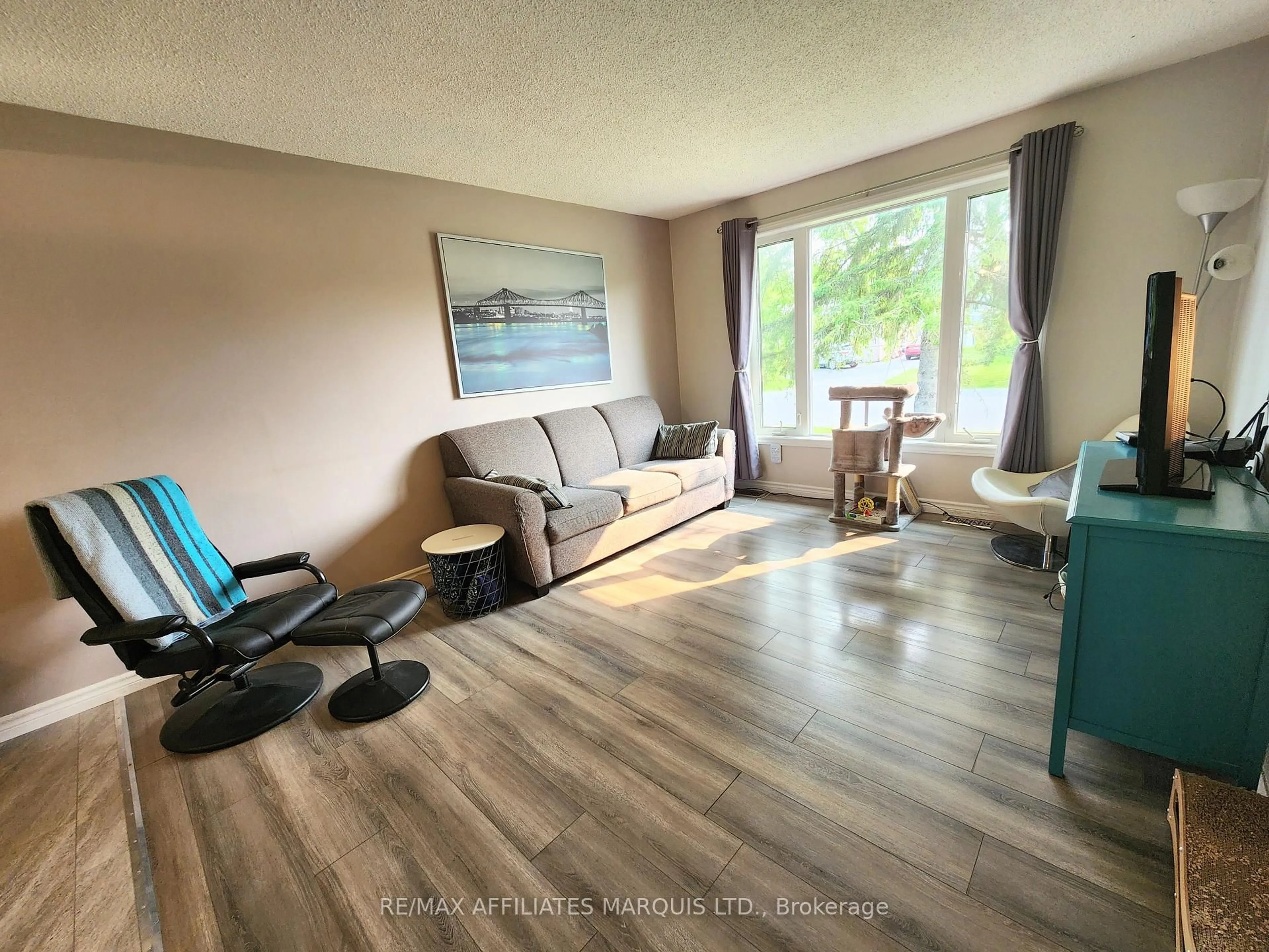 Living room with furniture, wood/laminate floor for 25 Piercy St, South Stormont Ontario K0C 1M0