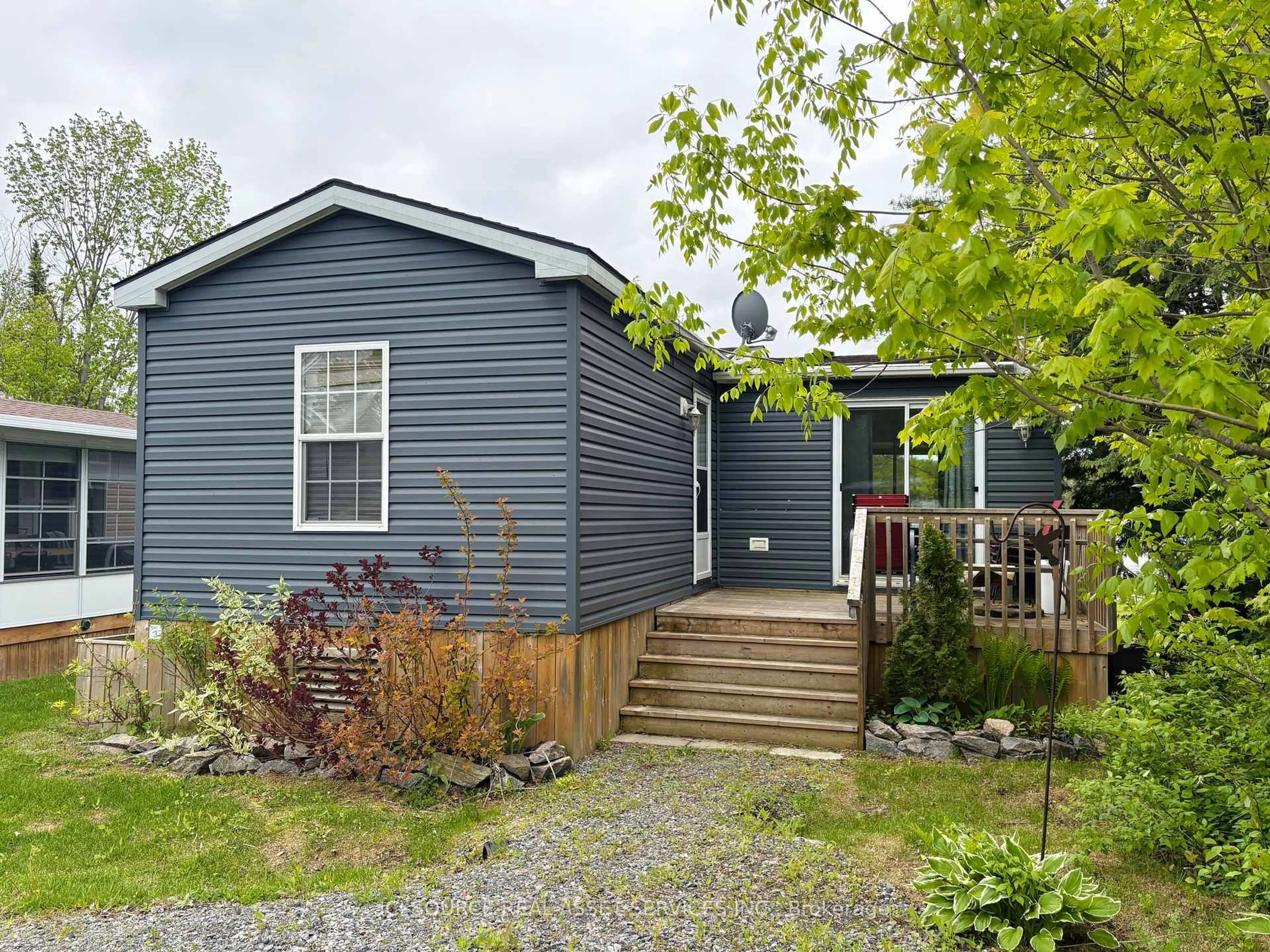Home with vinyl exterior material, street for 1047 Bonnie Lake Camp Rd #MNB03, Bracebridge Ontario P1L 1W9