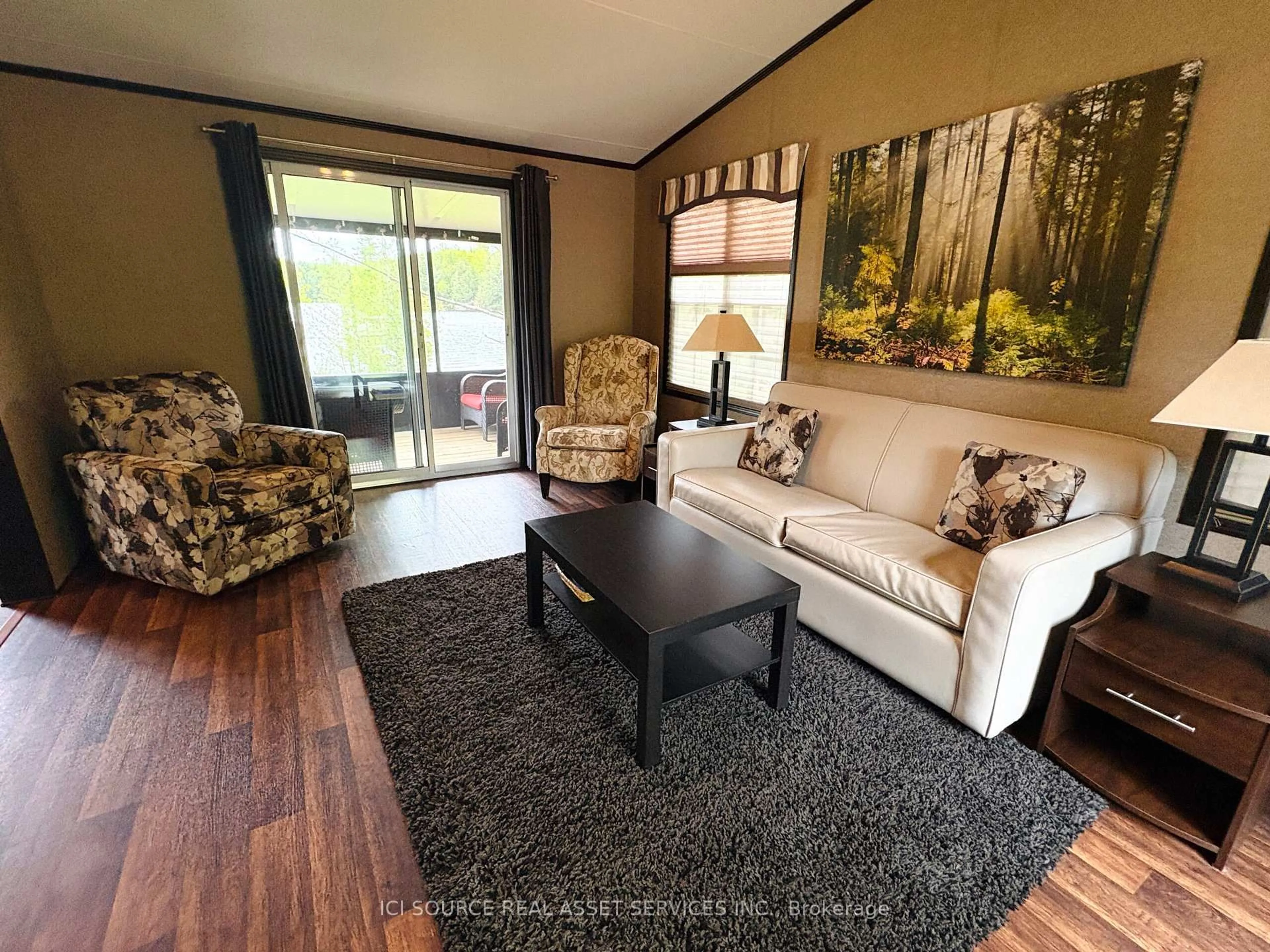 Living room with furniture, wood/laminate floor for 1047 Bonnie Lake Camp Rd #MNB03, Bracebridge Ontario P1L 1W9