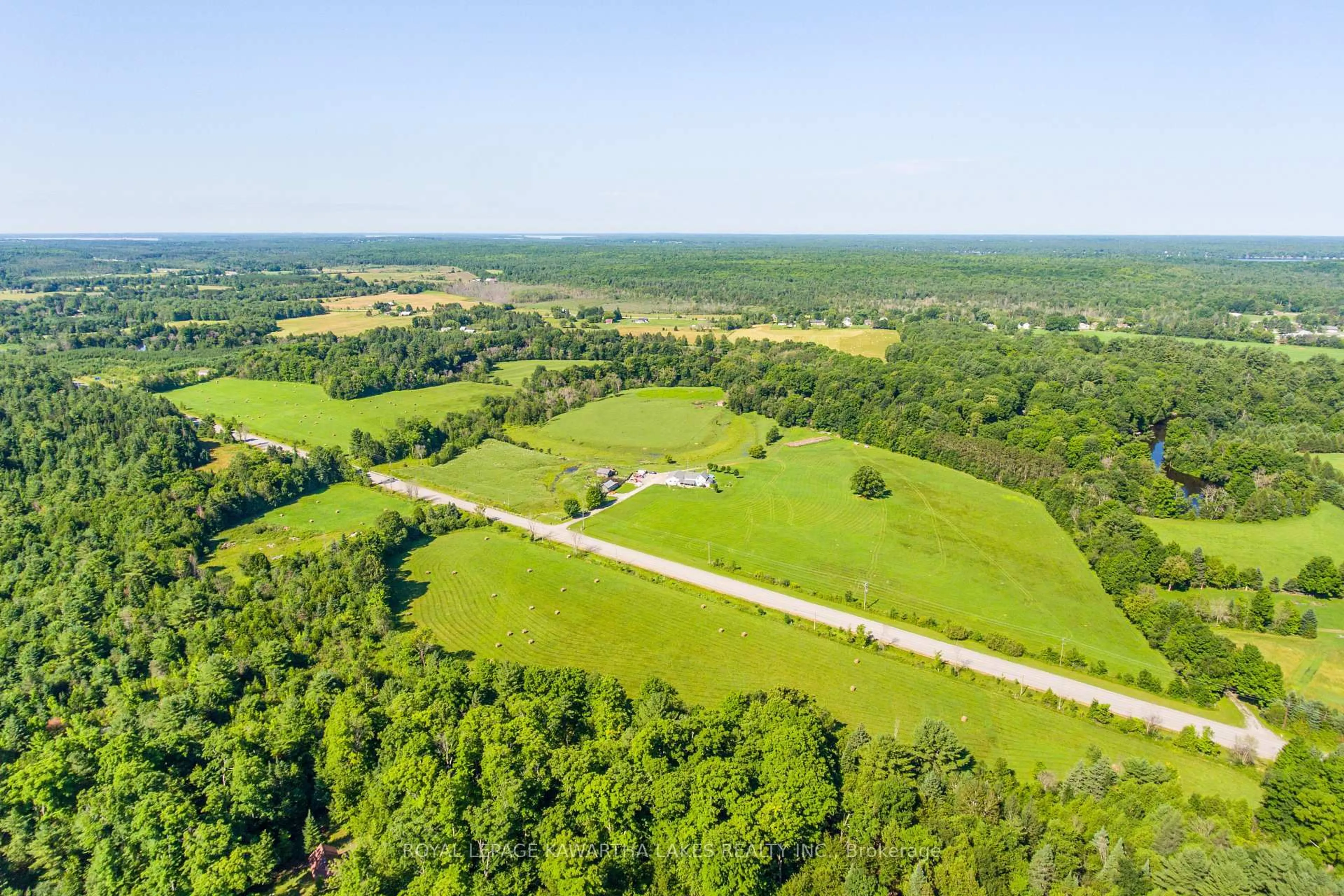 A pic from outside/outdoor area/front of a property/back of a property/a pic from drone, forest/trees view for 2433 County Road 121 Rd, Kawartha Lakes Ontario K0M 1C0