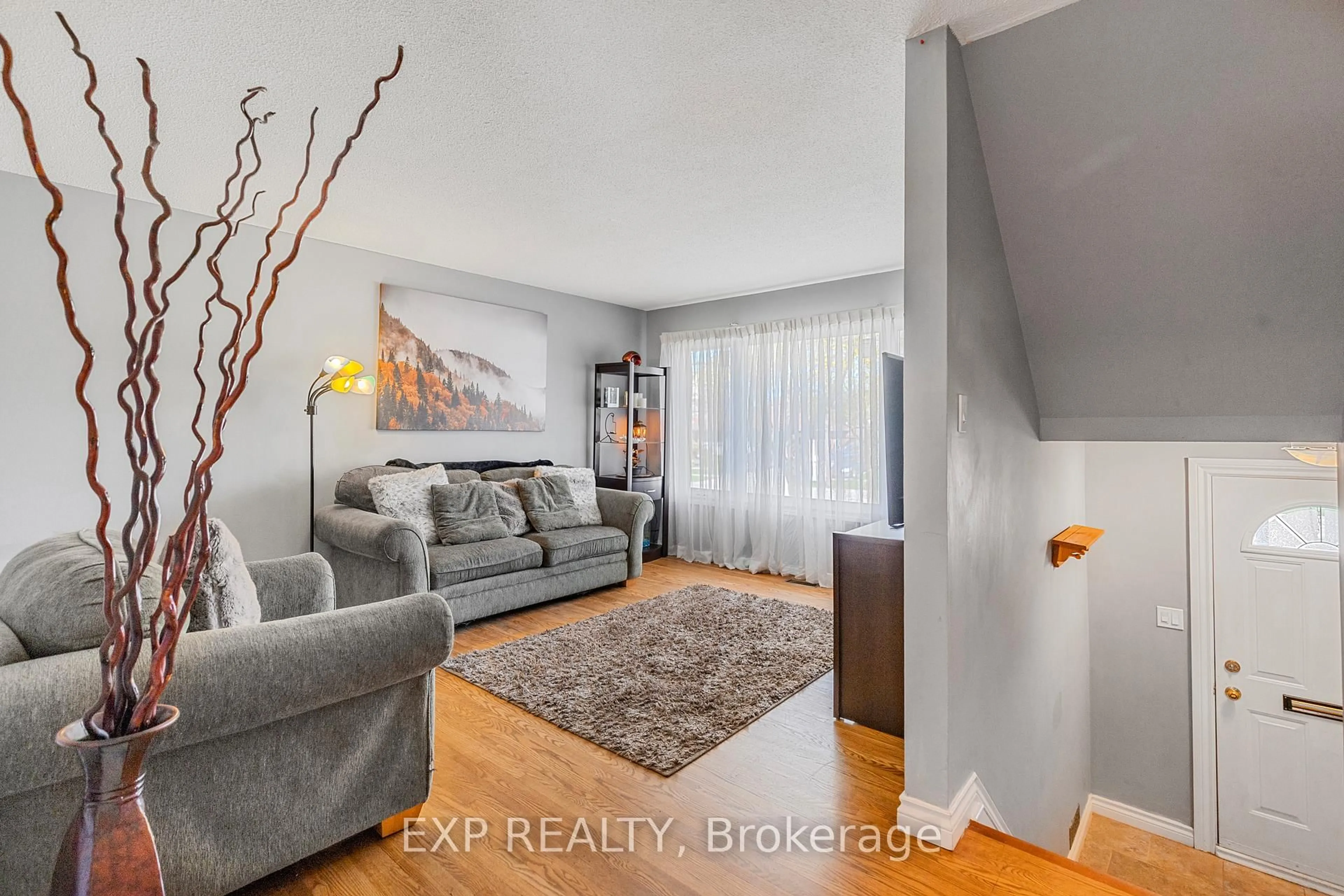 Living room with furniture, wood/laminate floor for 294 Quigley Rd, Hamilton Ontario L8K 5N1