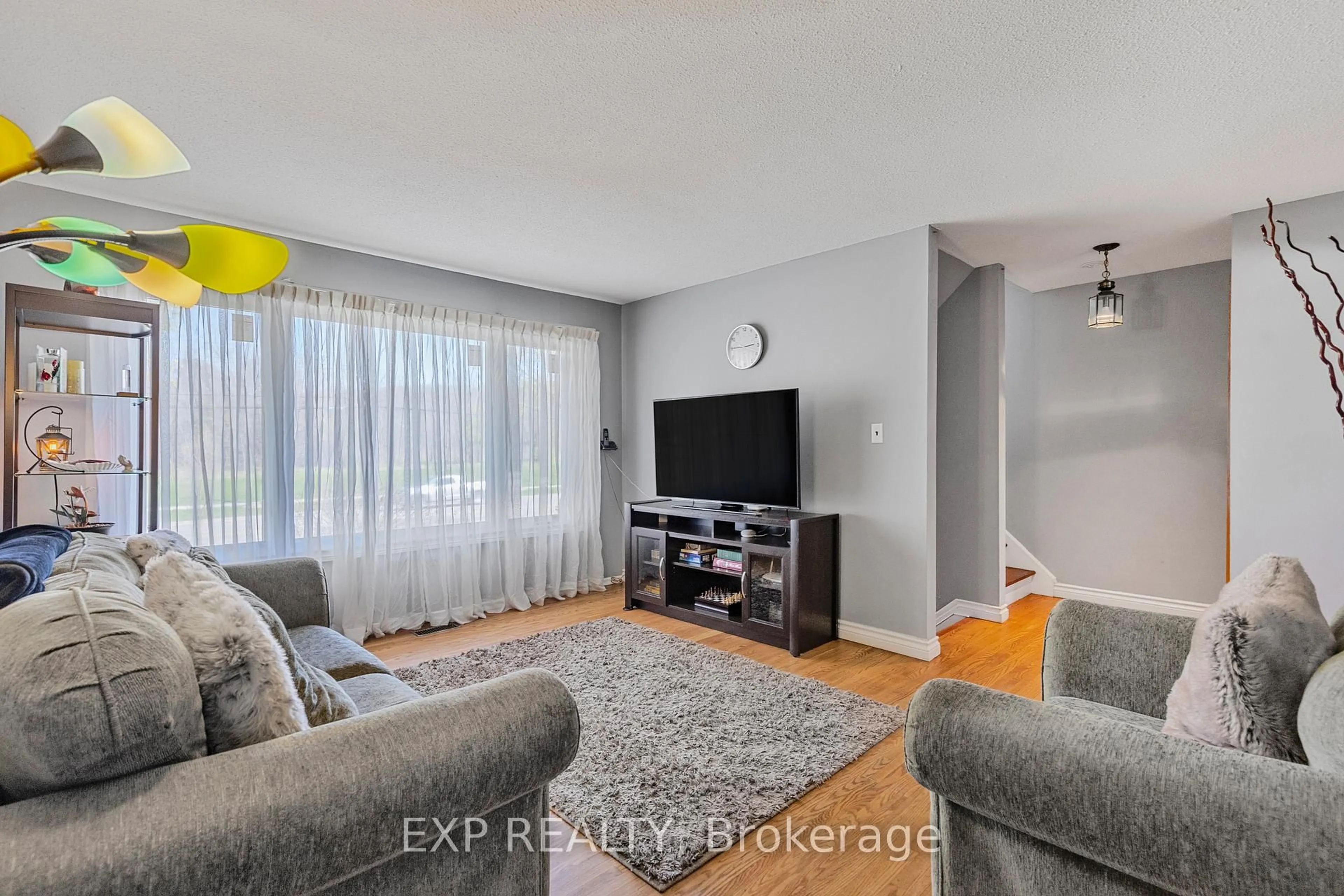 Living room with furniture, wood/laminate floor for 294 Quigley Rd, Hamilton Ontario L8K 5N1