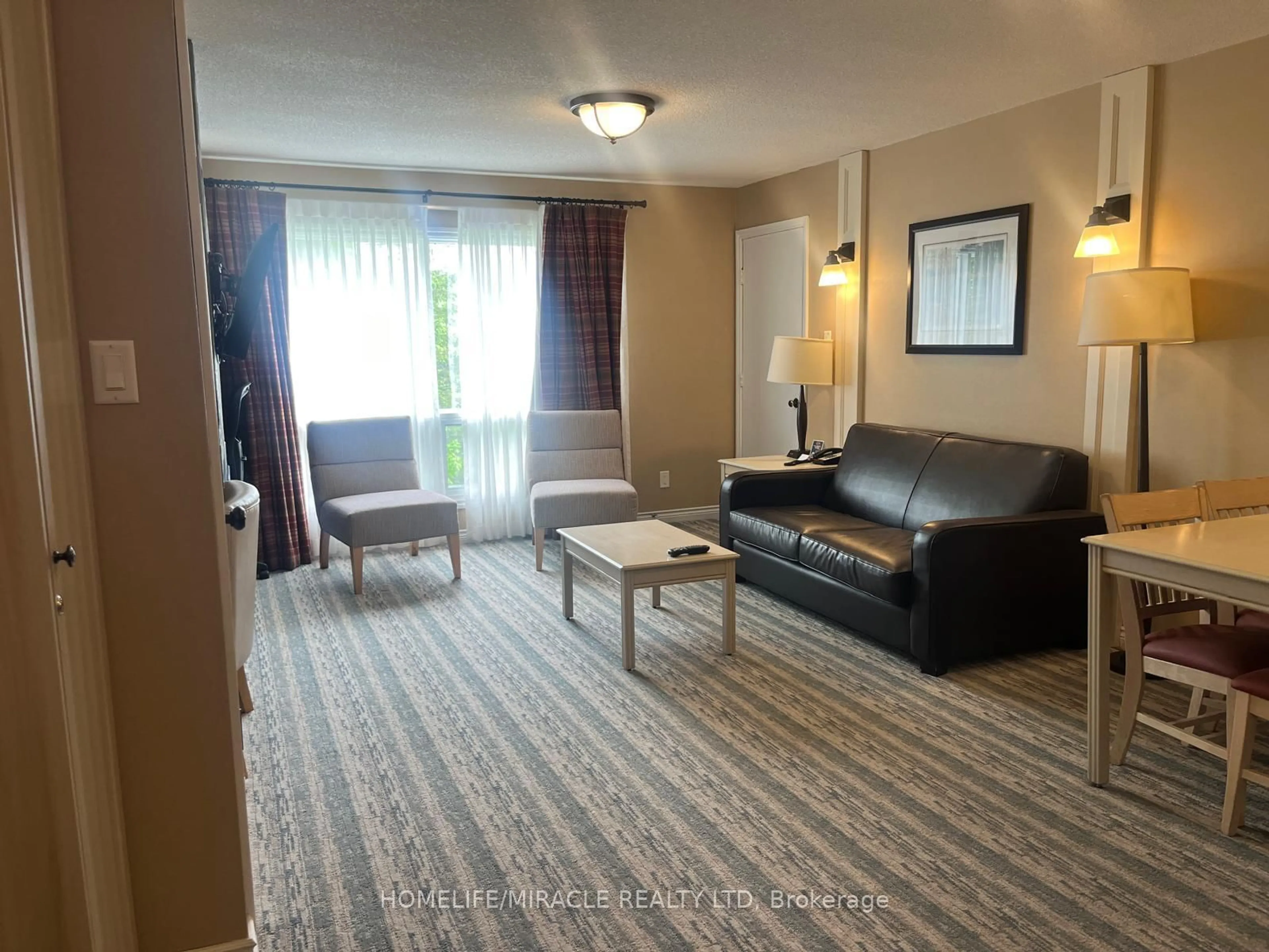 Living room with furniture, carpet floor for 1235 Deerhurst Dr #51/104, Huntsville Ontario P1H 2E8