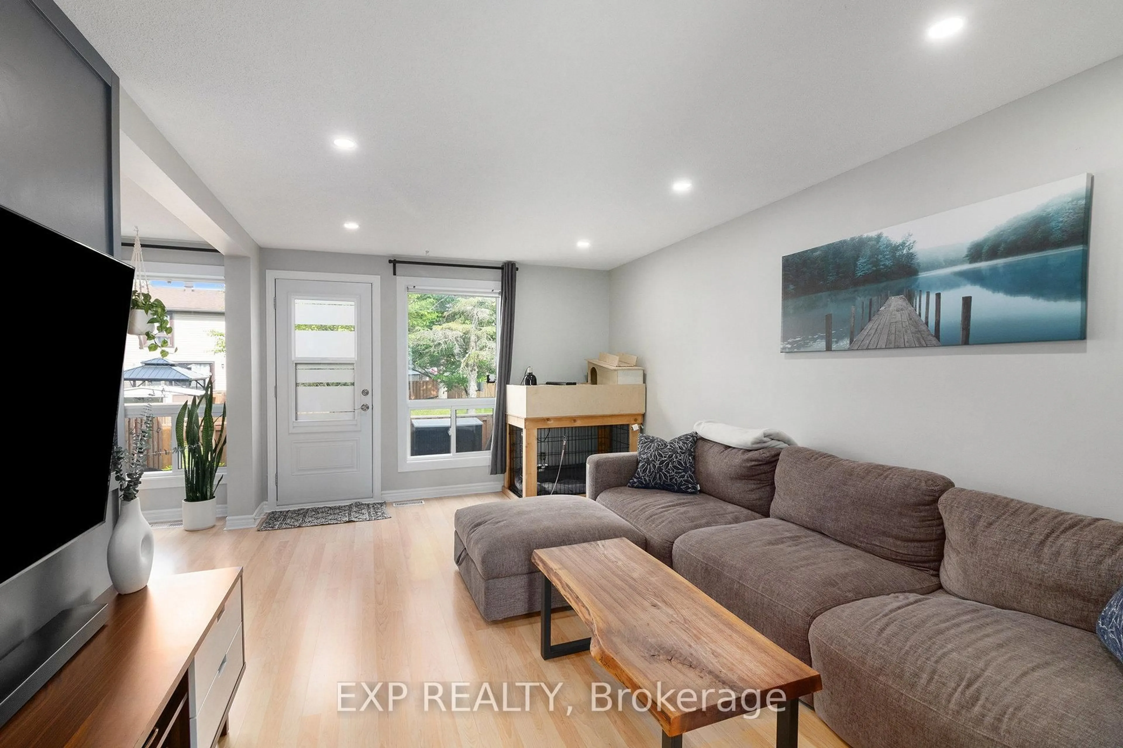 Living room with furniture, wood/laminate floor for 7804 Jeanne D'arc Blvd, Ottawa Ontario K1C 2E9