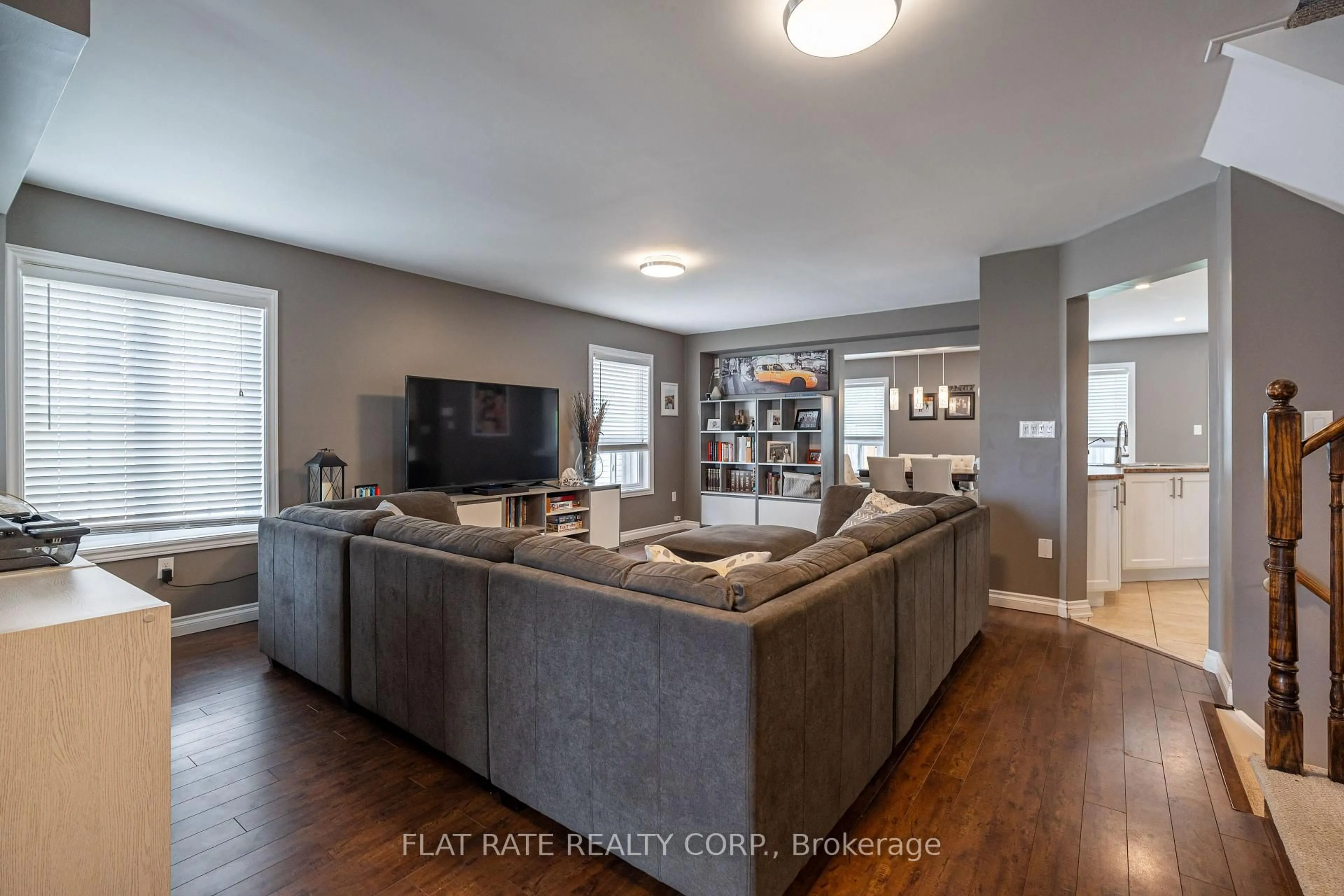 Living room with furniture, wood/laminate floor for 696 Tully Cres, Peterborough West Ontario K9K 0A9