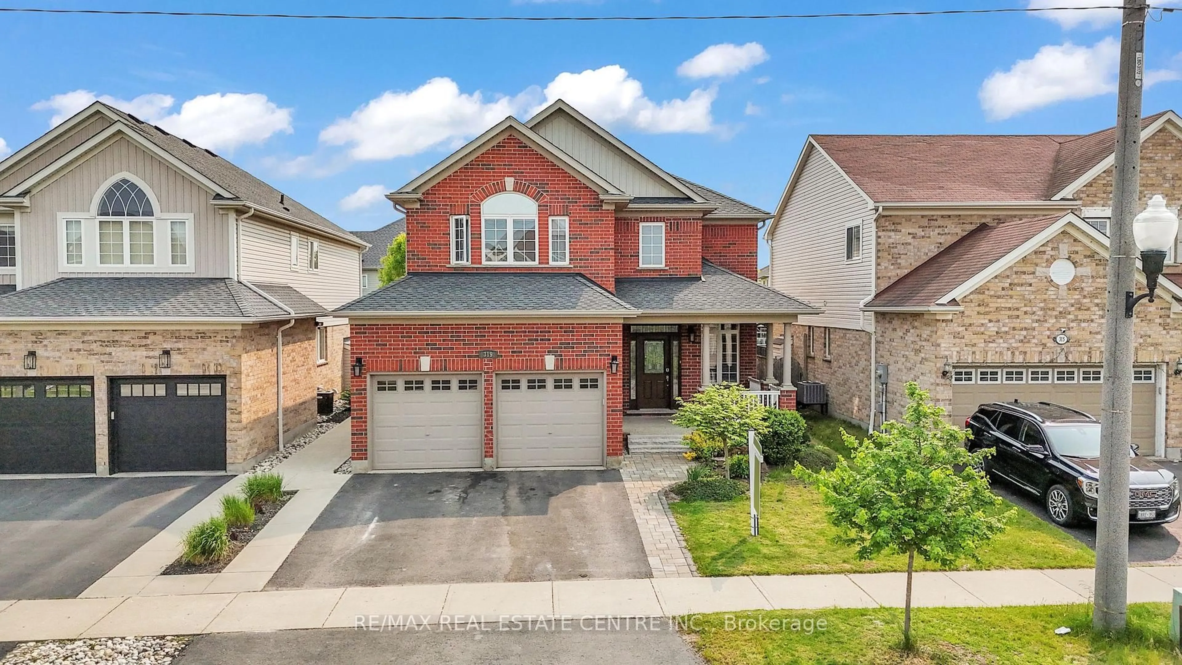 Home with brick exterior material, street for 319 Robert Ferrie Dr, Kitchener Ontario N2P 2Y7