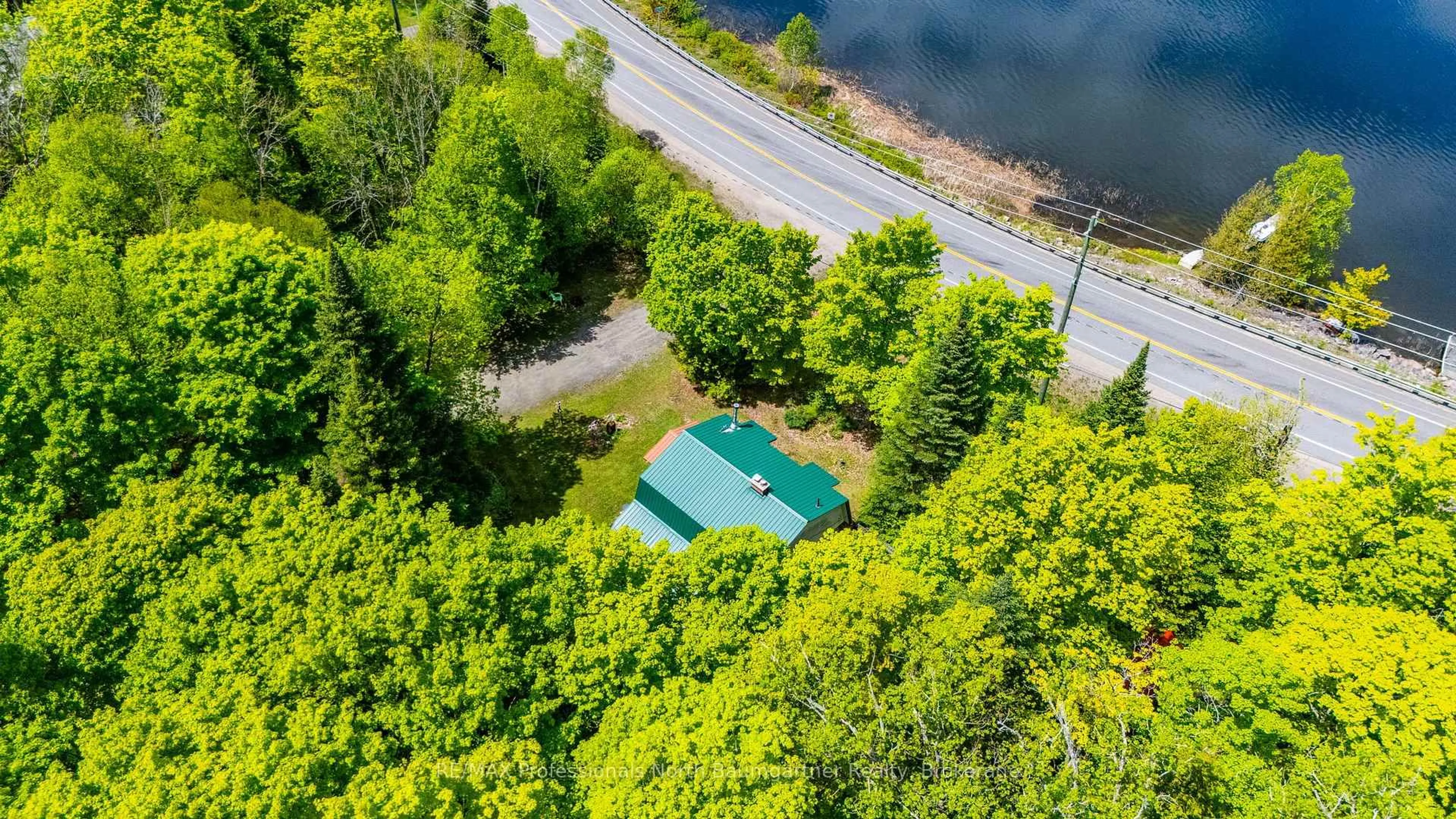 A pic from outside/outdoor area/front of a property/back of a property/a pic from drone, water/lake/river/ocean view for 18053 Highway 35, Algonquin Highlands Ontario K0M 1J2