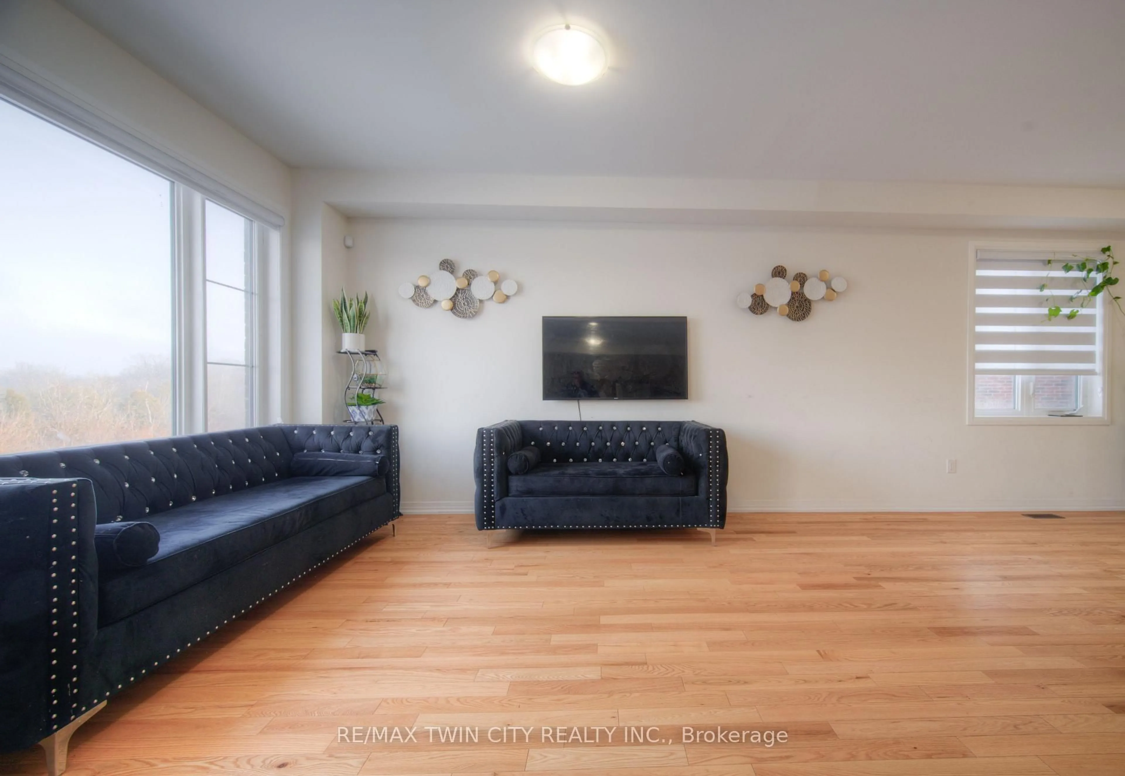 Living room with furniture, wood/laminate floor for 67 Crossmore Cres, Cambridge Ontario N1S 0C7