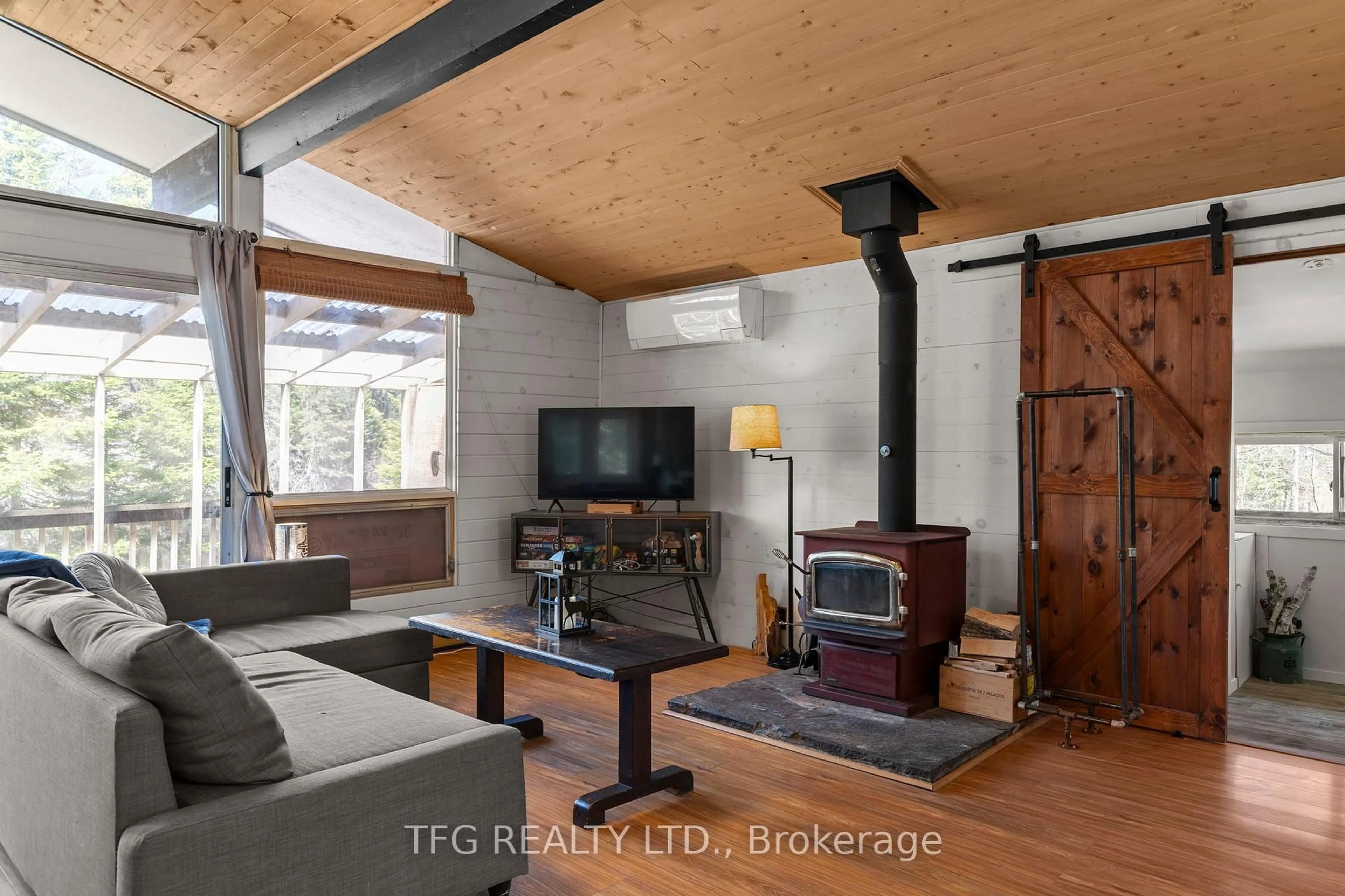 Living room with furniture, wood/laminate floor for 449 Balsam Chutes Rd, Huntsville Ontario P0B 1L0
