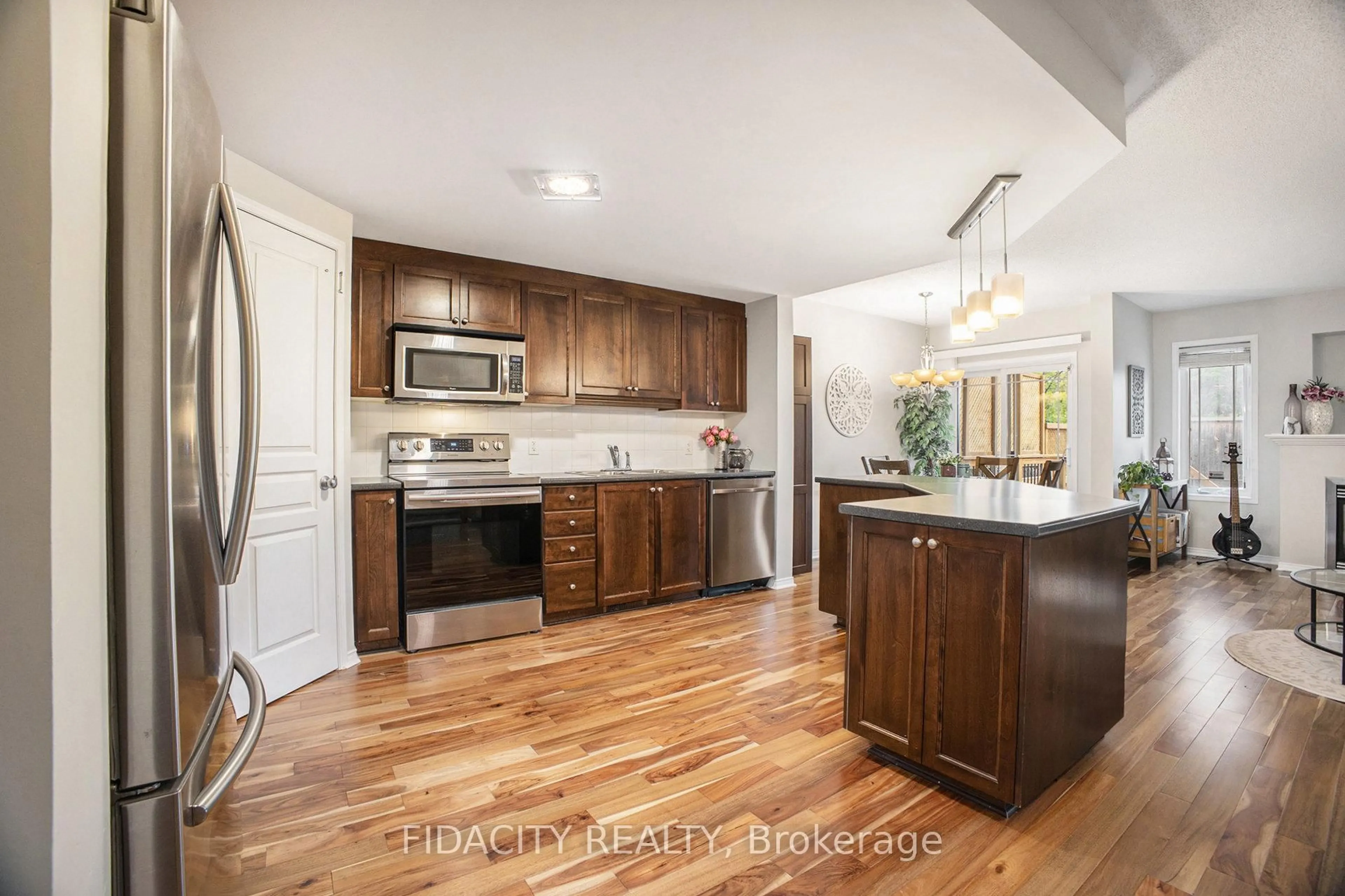Open concept kitchen, wood/laminate floor for 1493 Carronbridge Circ, Ottawa Ontario K2M 0G7