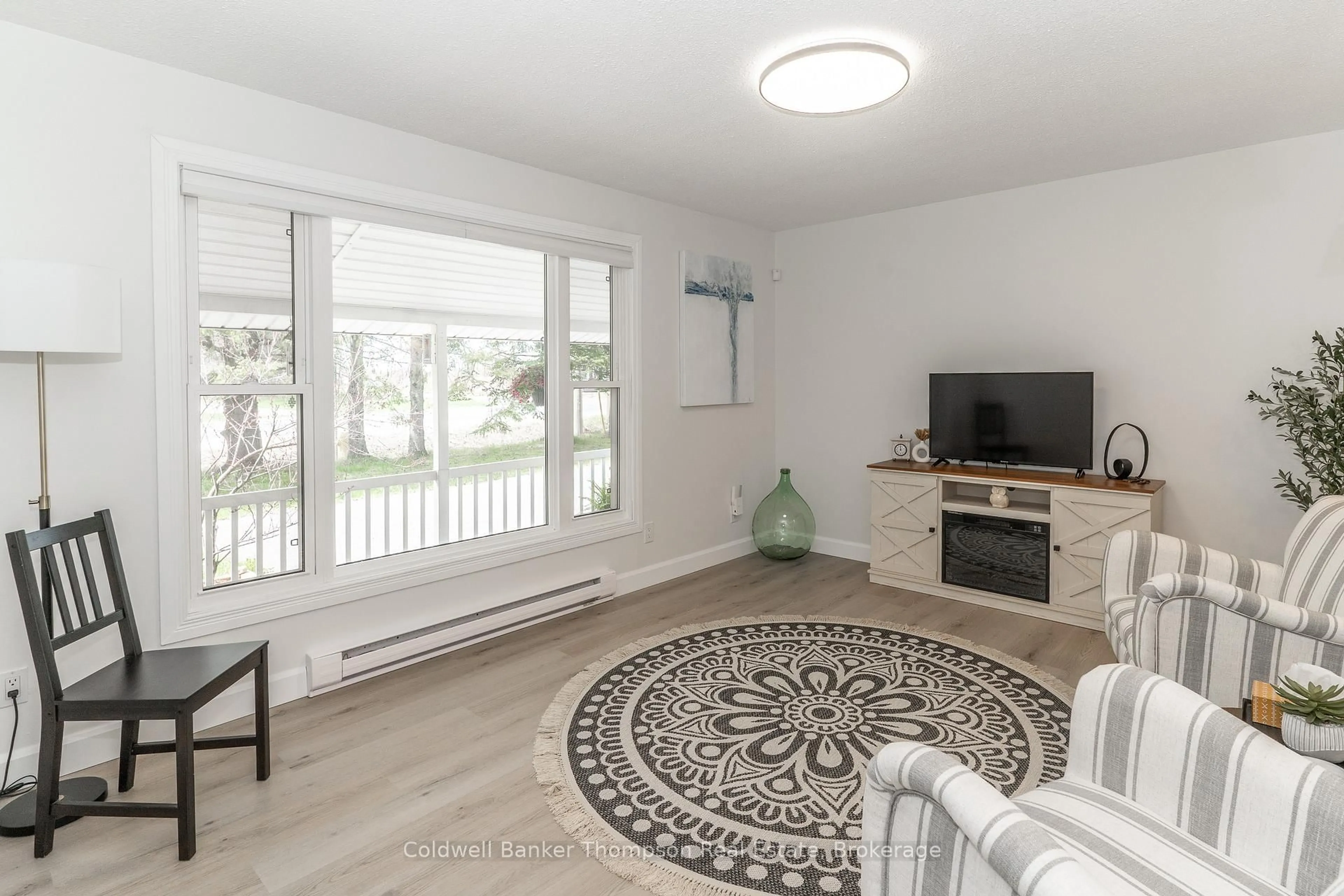 Living room with furniture, unknown for 209 Ravensglen Dr, Huntsville Ontario P1H 1L7