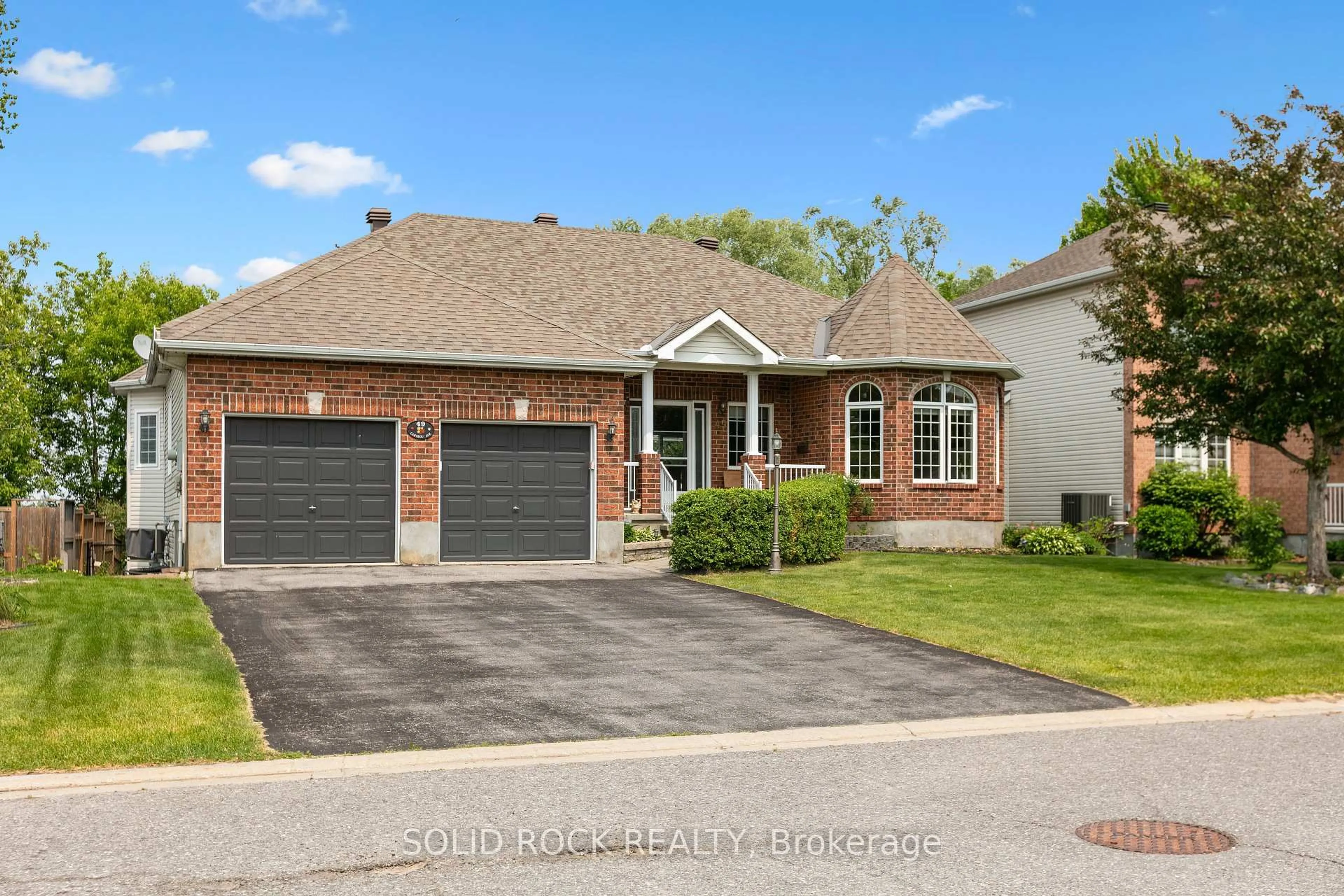 Home with brick exterior material, street for 49 Caribou Ave, Stittsville Ontario K2S 1X3