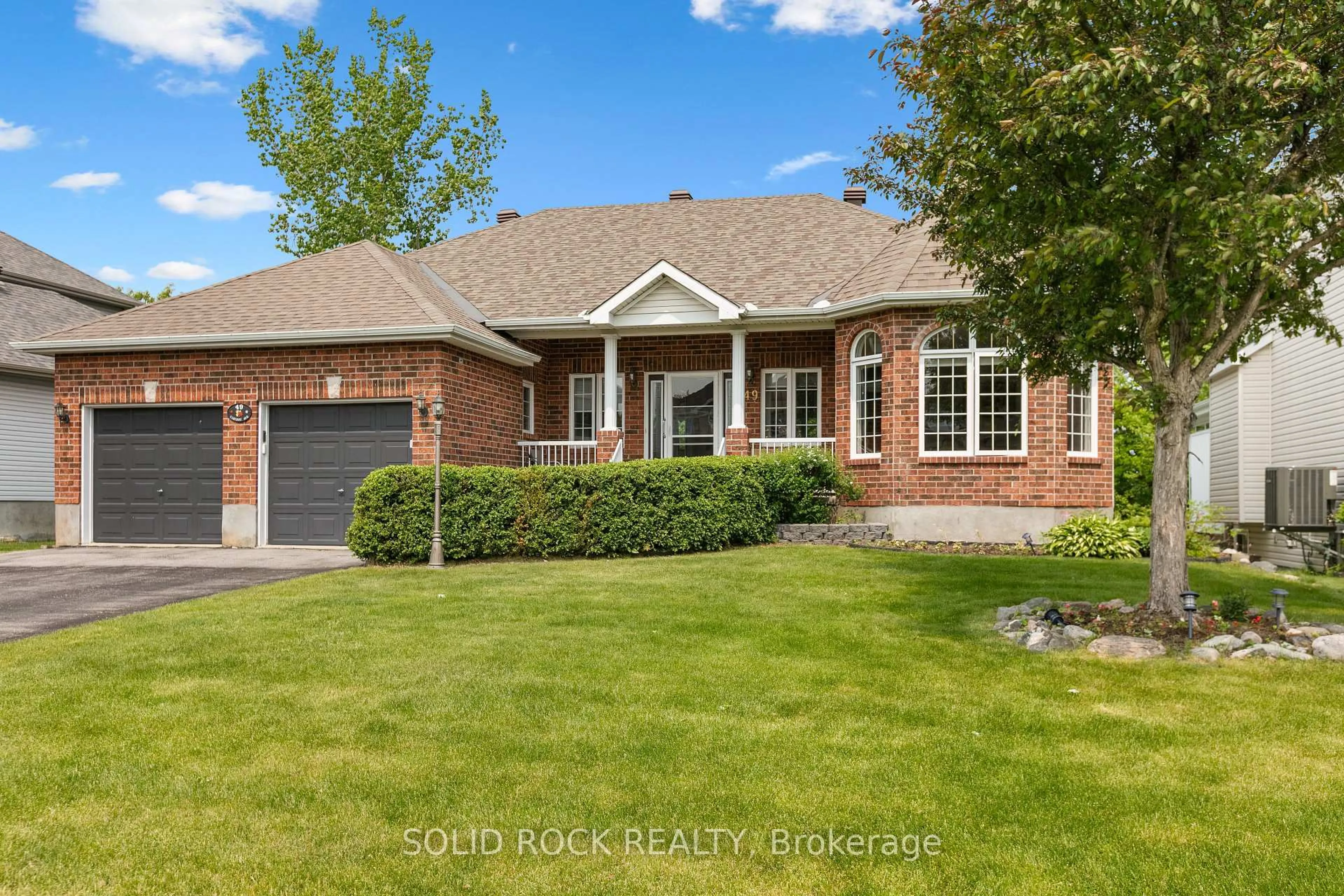 Home with brick exterior material, street for 49 Caribou Ave, Stittsville Ontario K2S 1X3