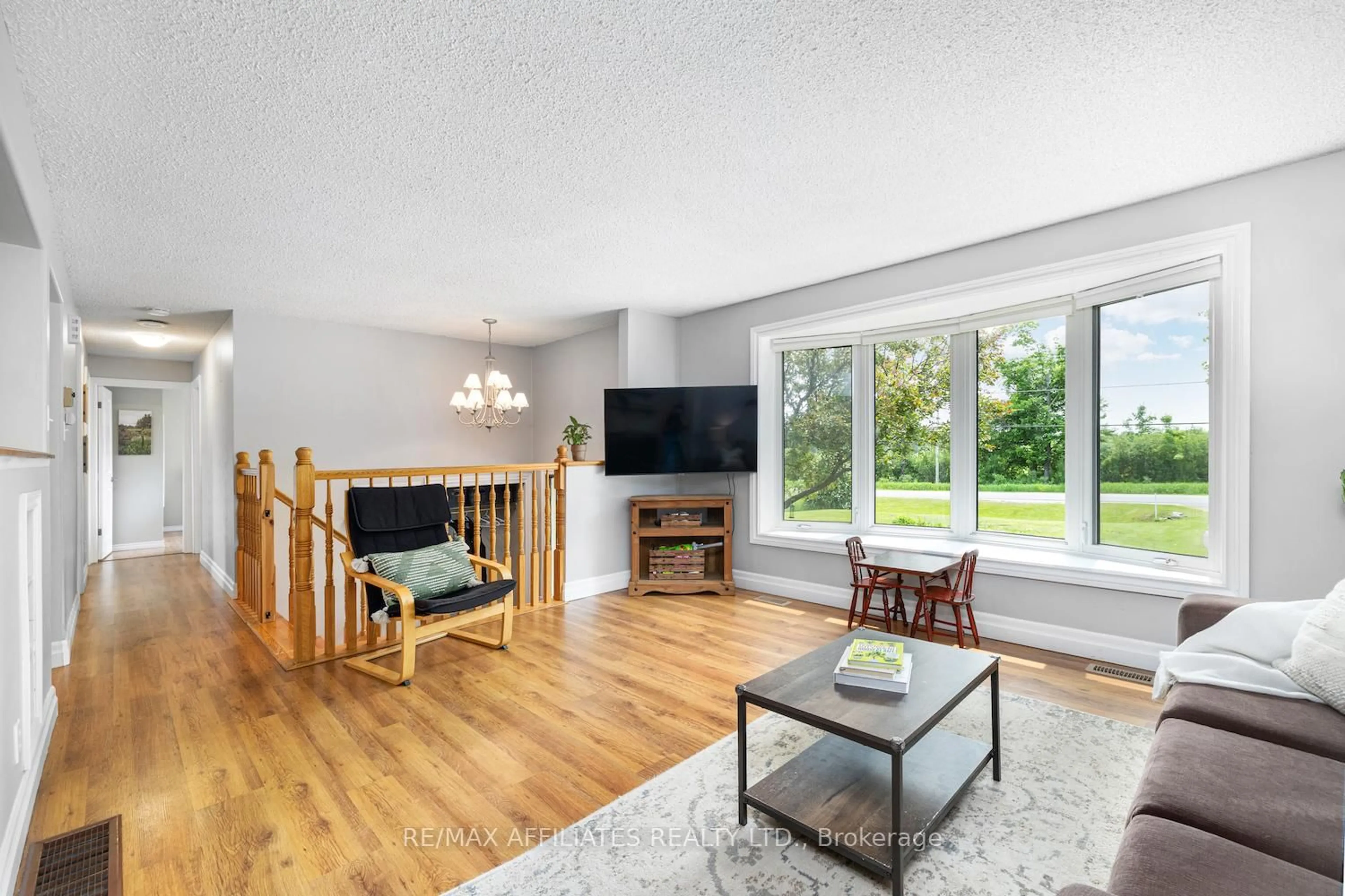 Living room with furniture, wood/laminate floor for 1494 RAMSAY 8 CON Rd, Almonte Ontario K0A 1A0