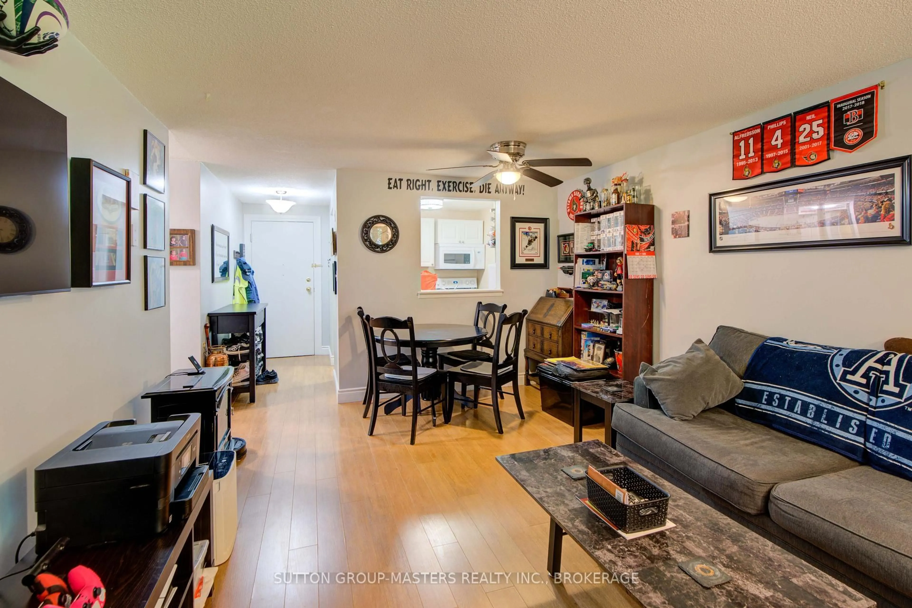 Living room with furniture, wood/laminate floor for 580 Armstrong Rd, Kingston Ontario K7M 8M3