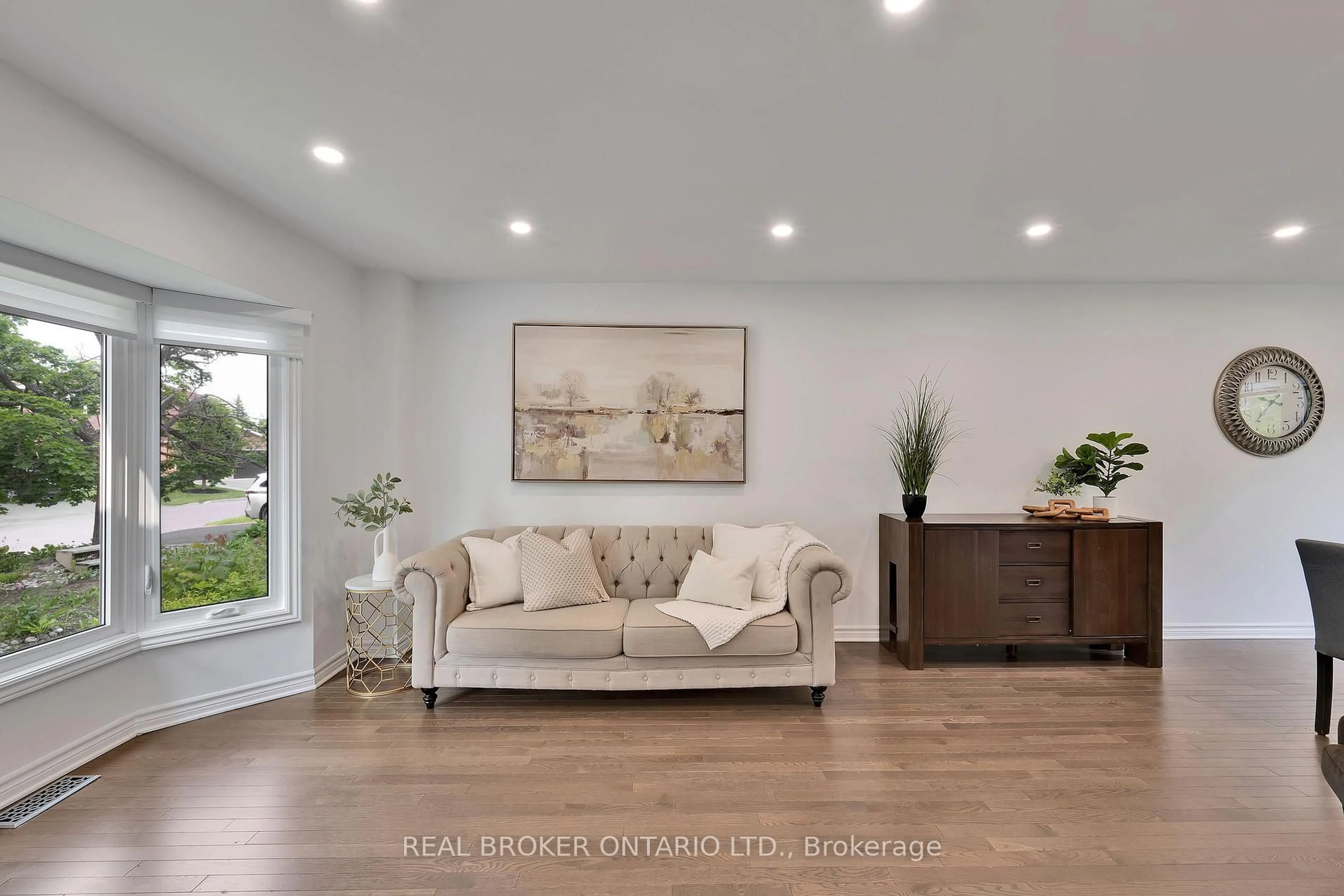 Living room with furniture, wood/laminate floor for 630 Apollo Way, Ottawa Ontario K4A 1T4