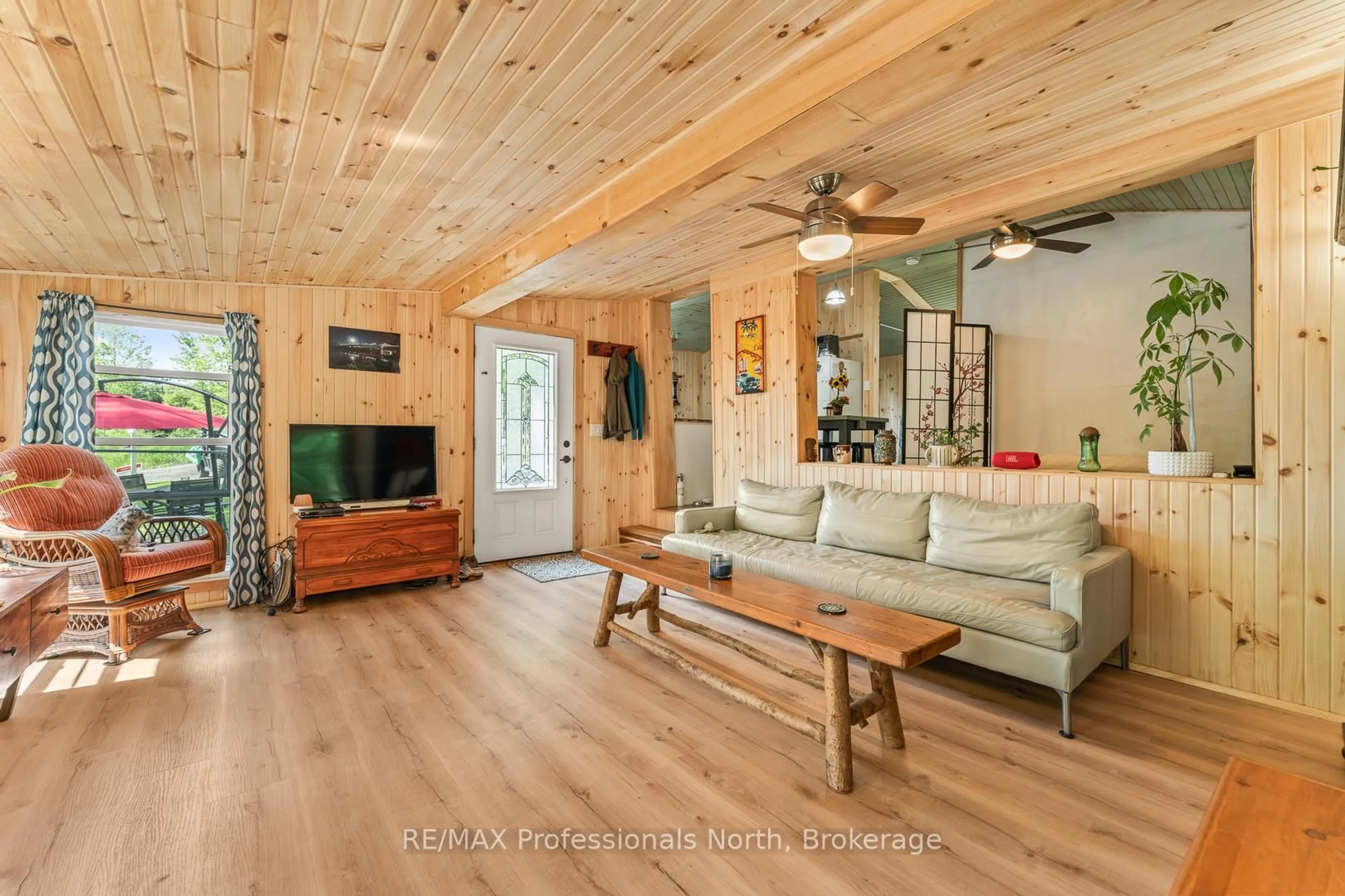 Living room with furniture, wood/laminate floor for 1053 Cutler Rd, Muskoka Lakes Ontario P0B 1M0