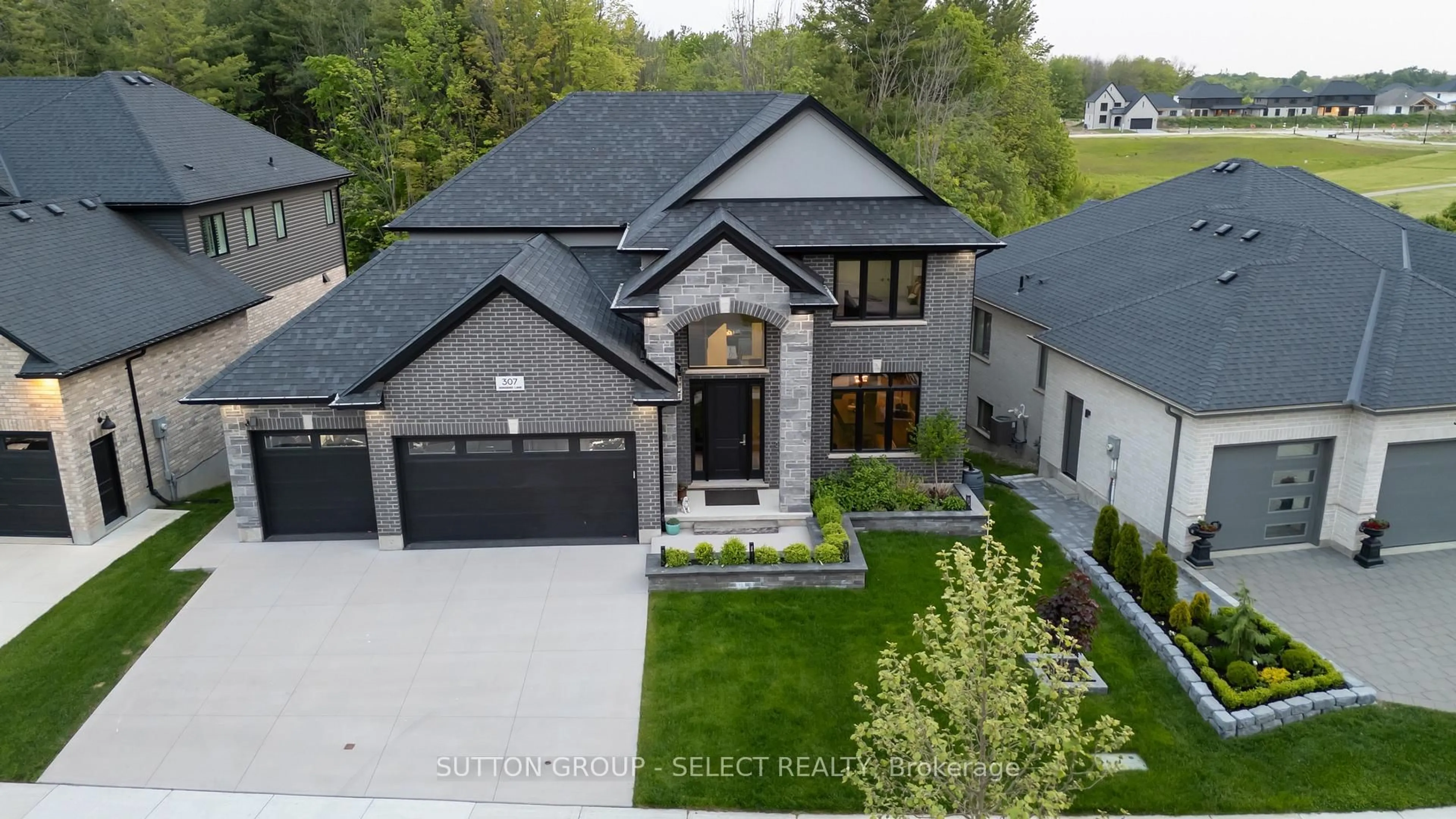 Home with brick exterior material, street for 307 Songbird Lane, Middlesex Centre Ontario N0M 2A0