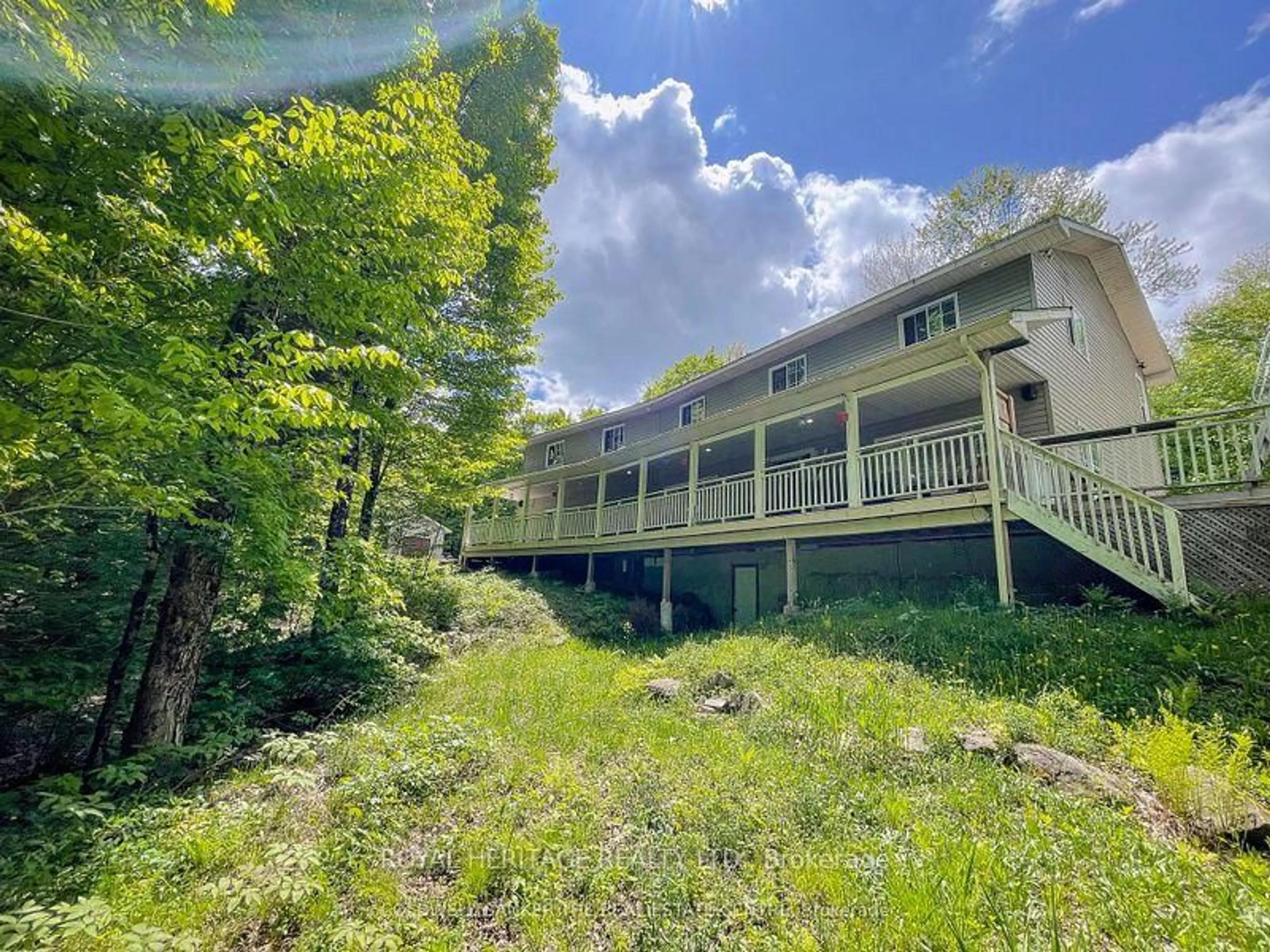 A pic from outside/outdoor area/front of a property/back of a property/a pic from drone, water/lake/river/ocean view for 1030 Purbrook Rd, Bracebridge Ontario P1L 1X3