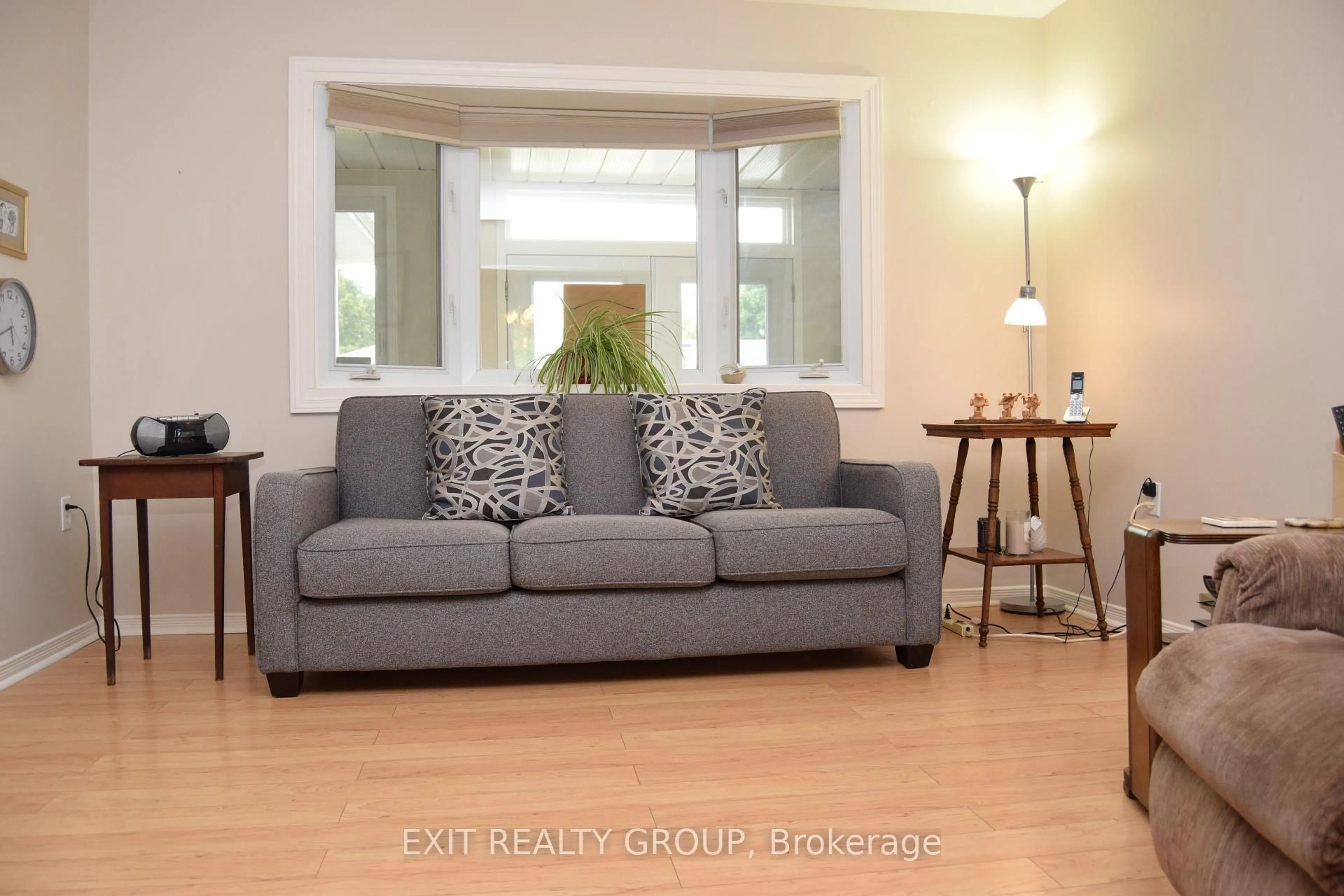 Living room with furniture, wood/laminate floor for 9 Empire Blvd, Prince Edward County Ontario K0K 3L0