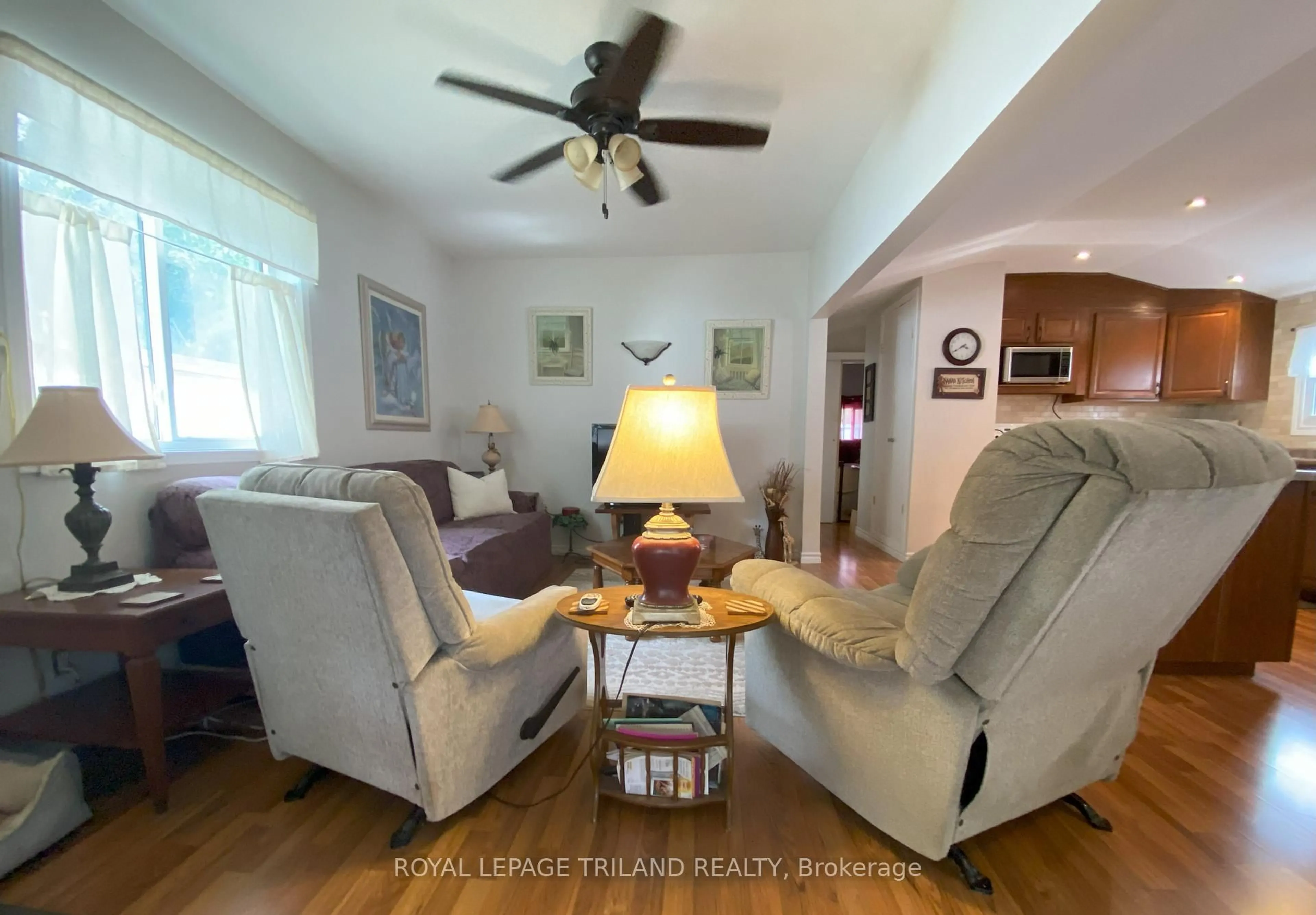 Living room with furniture, wood/laminate floor for 9951 Northville Cres #2, Lambton Shores Ontario N0M 2N0