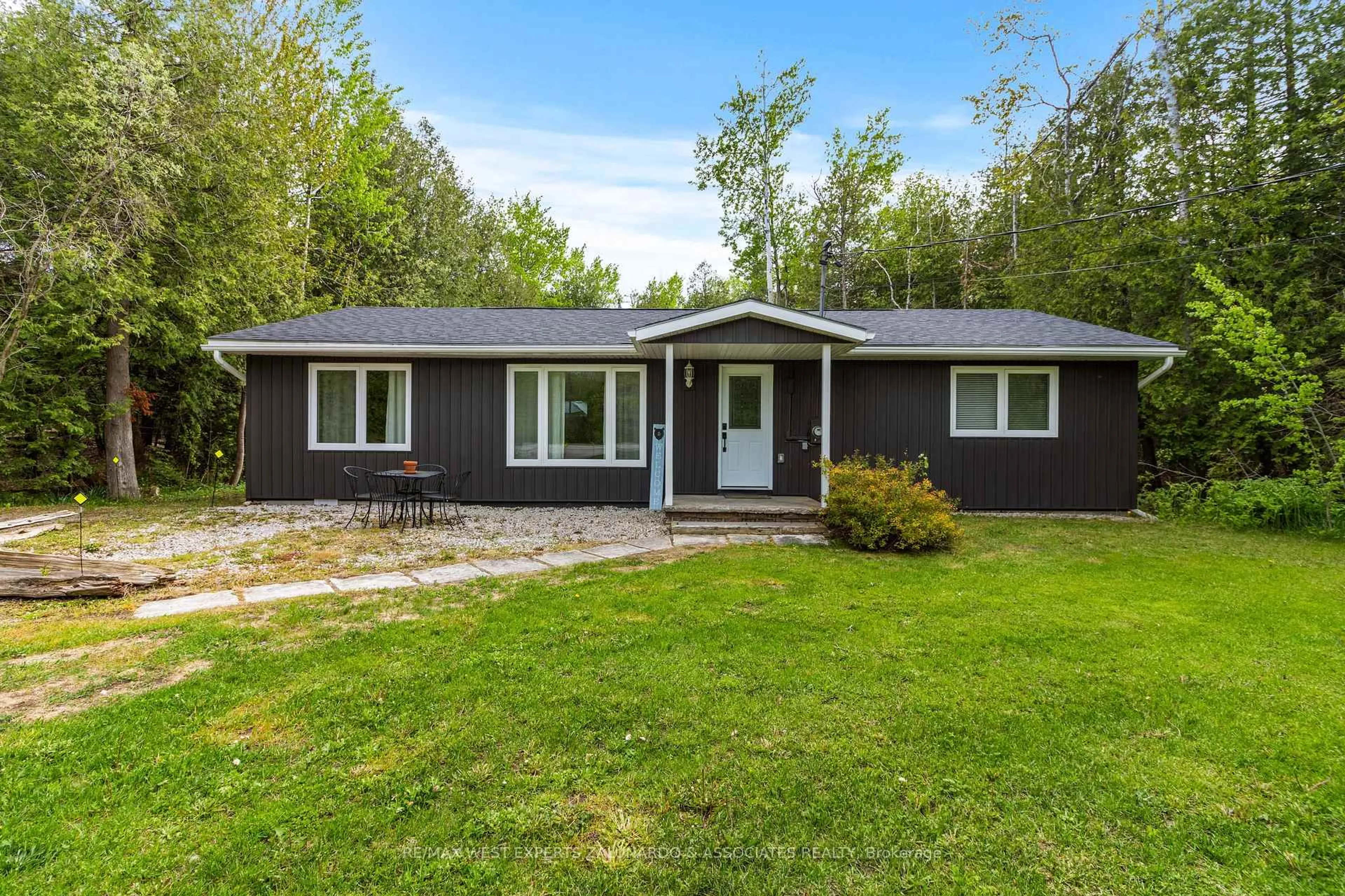 Home with vinyl exterior material, street for 7221 Highway 6 Rd, Northern Bruce Peninsula Ontario N0H 2T0