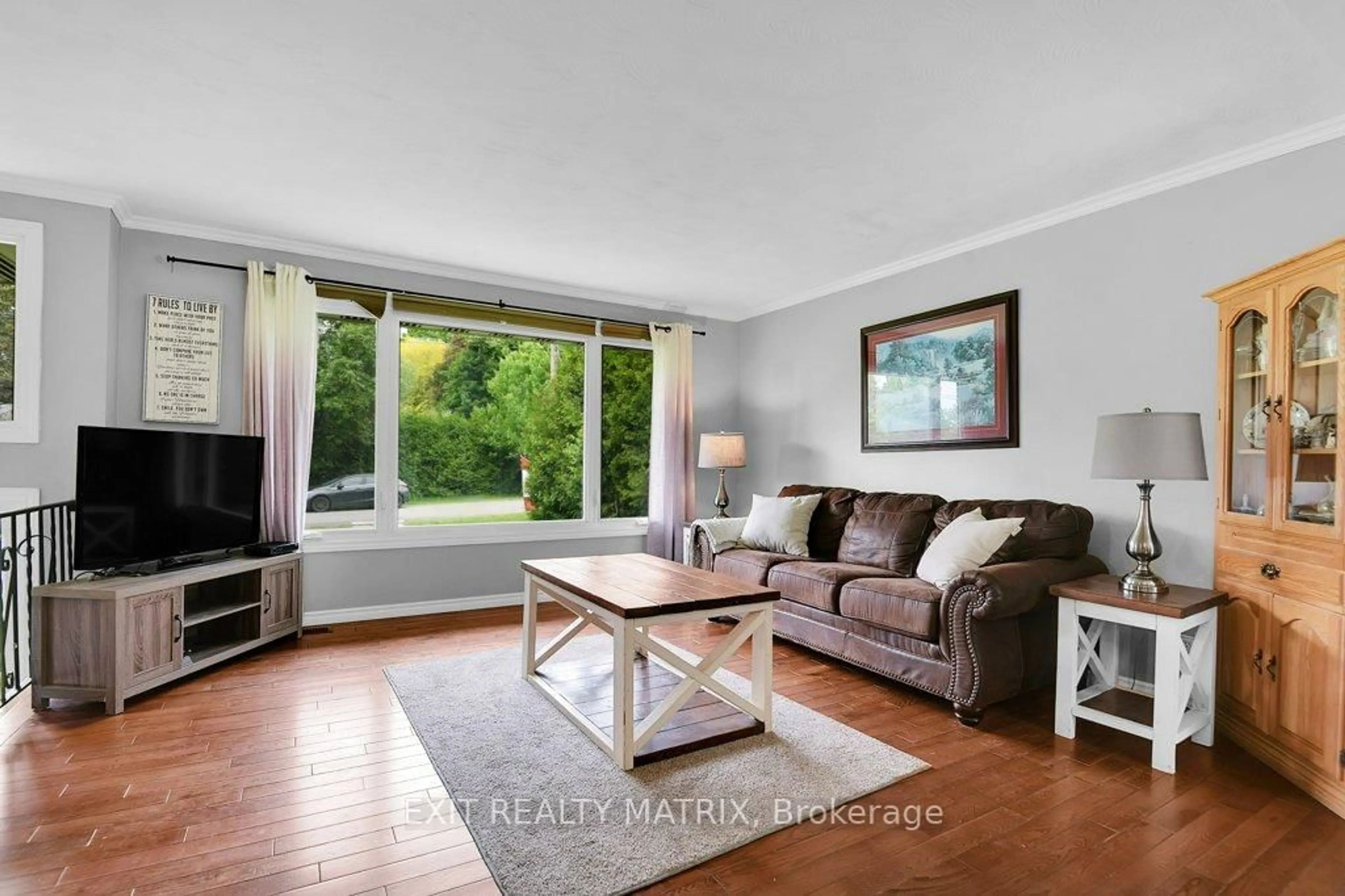 Living room with furniture, wood/laminate floor for 8296 Corlyon St, Metcalfe Ontario K0A 2P0