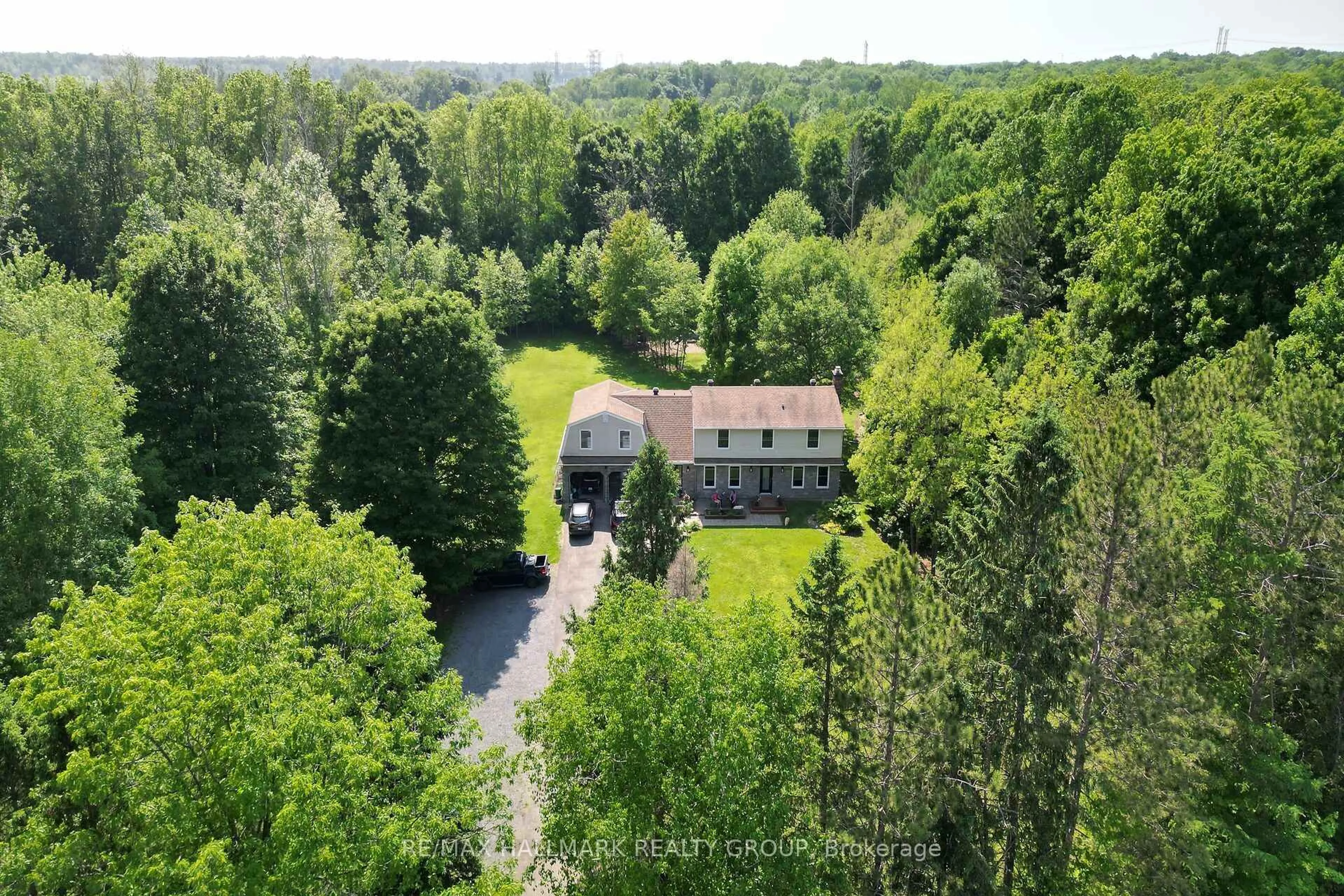A pic from outside/outdoor area/front of a property/back of a property/a pic from drone, forest/trees view for 1430 Royal Maple Dr, Cumberland Ontario K4C 1B5