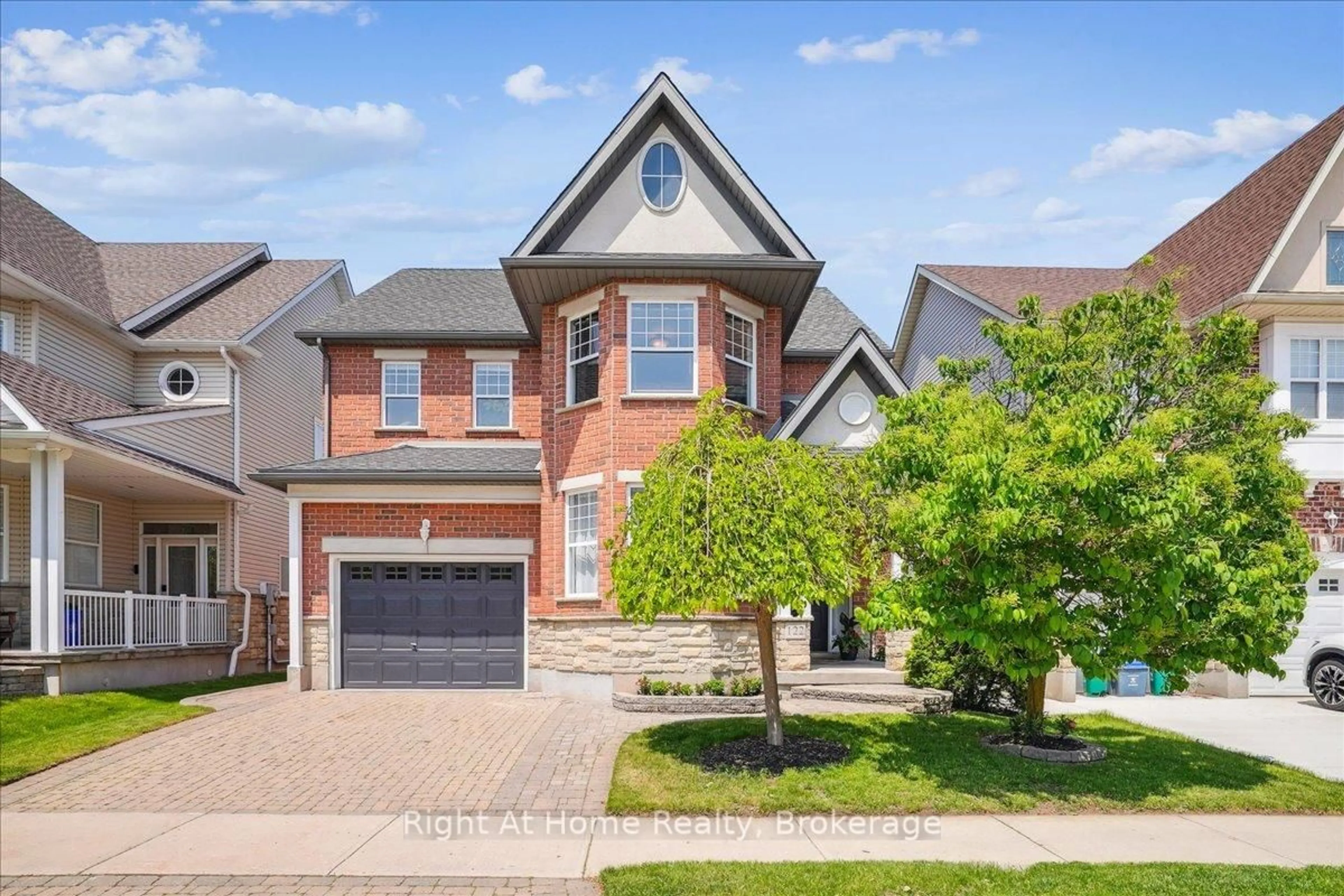 Home with brick exterior material, street for 122 Hawkswood Dr, Kitchener Ontario N2K 4J4