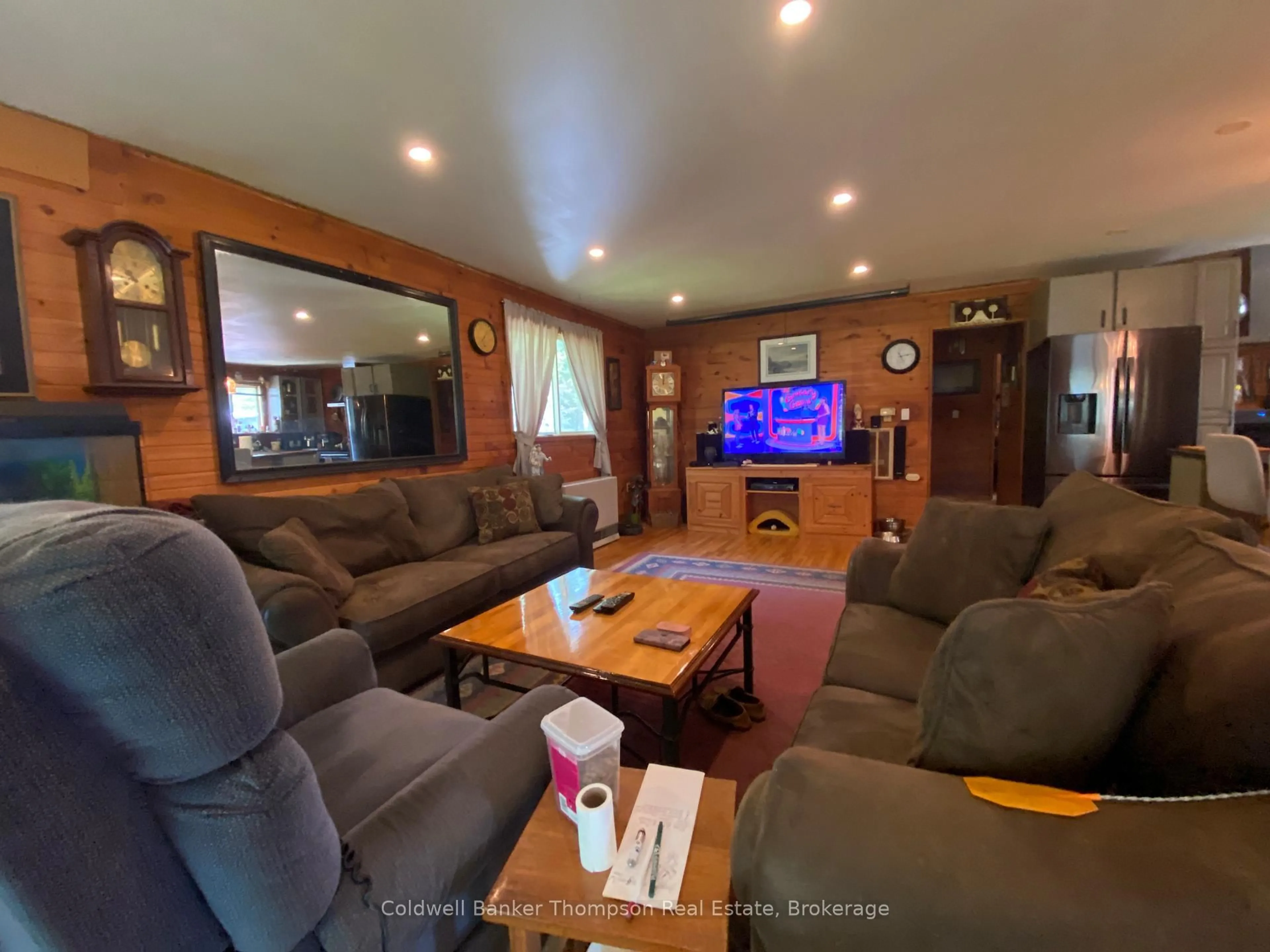 Living room with furniture, wood/laminate floor for 83 Leighton Rd, Machar Ontario P0A 1X0