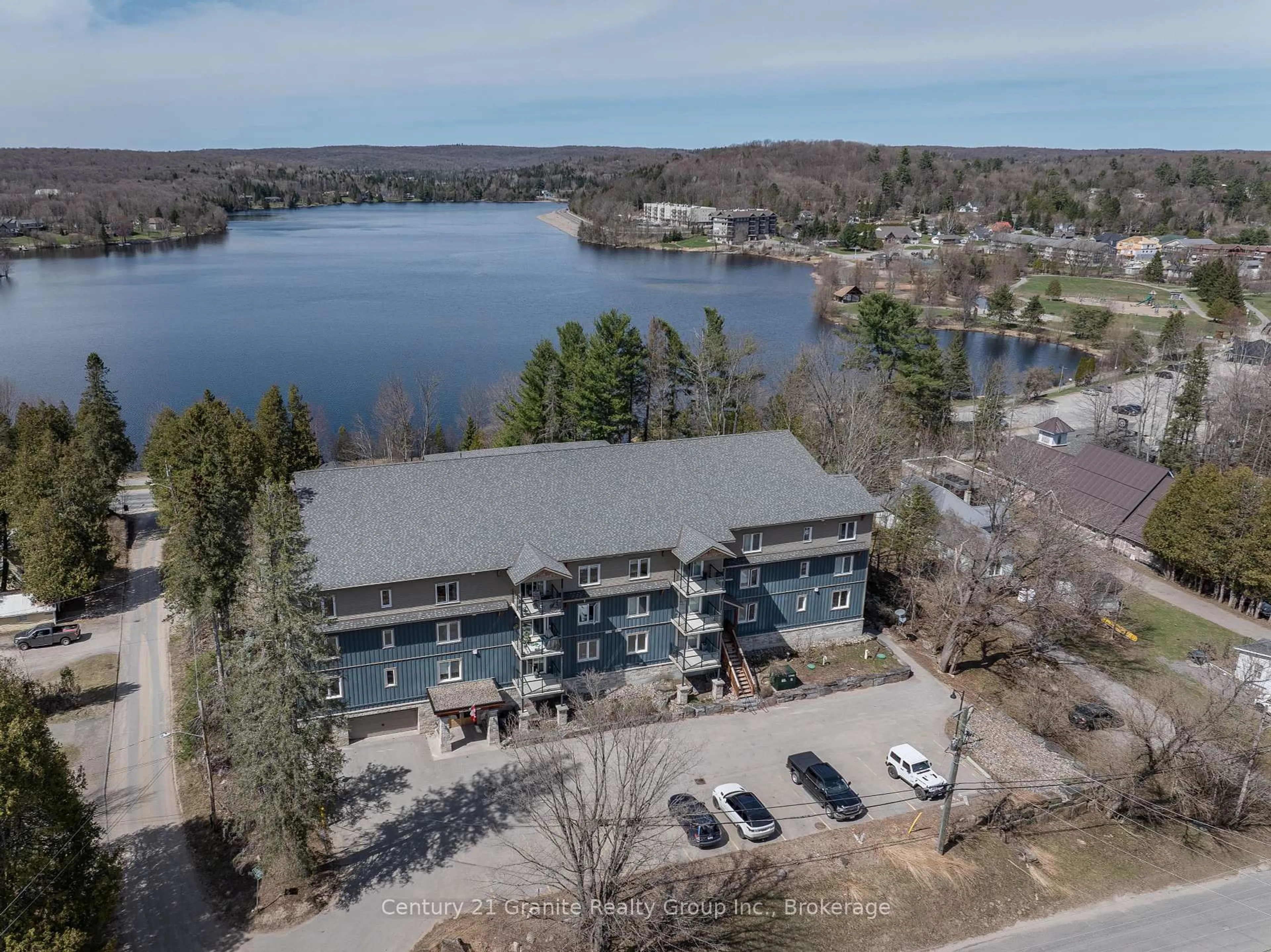 A pic from outside/outdoor area/front of a property/back of a property/a pic from drone, water/lake/river/ocean view for 4 Lake Ave #203, Dysart et al Ontario K0M 1S0