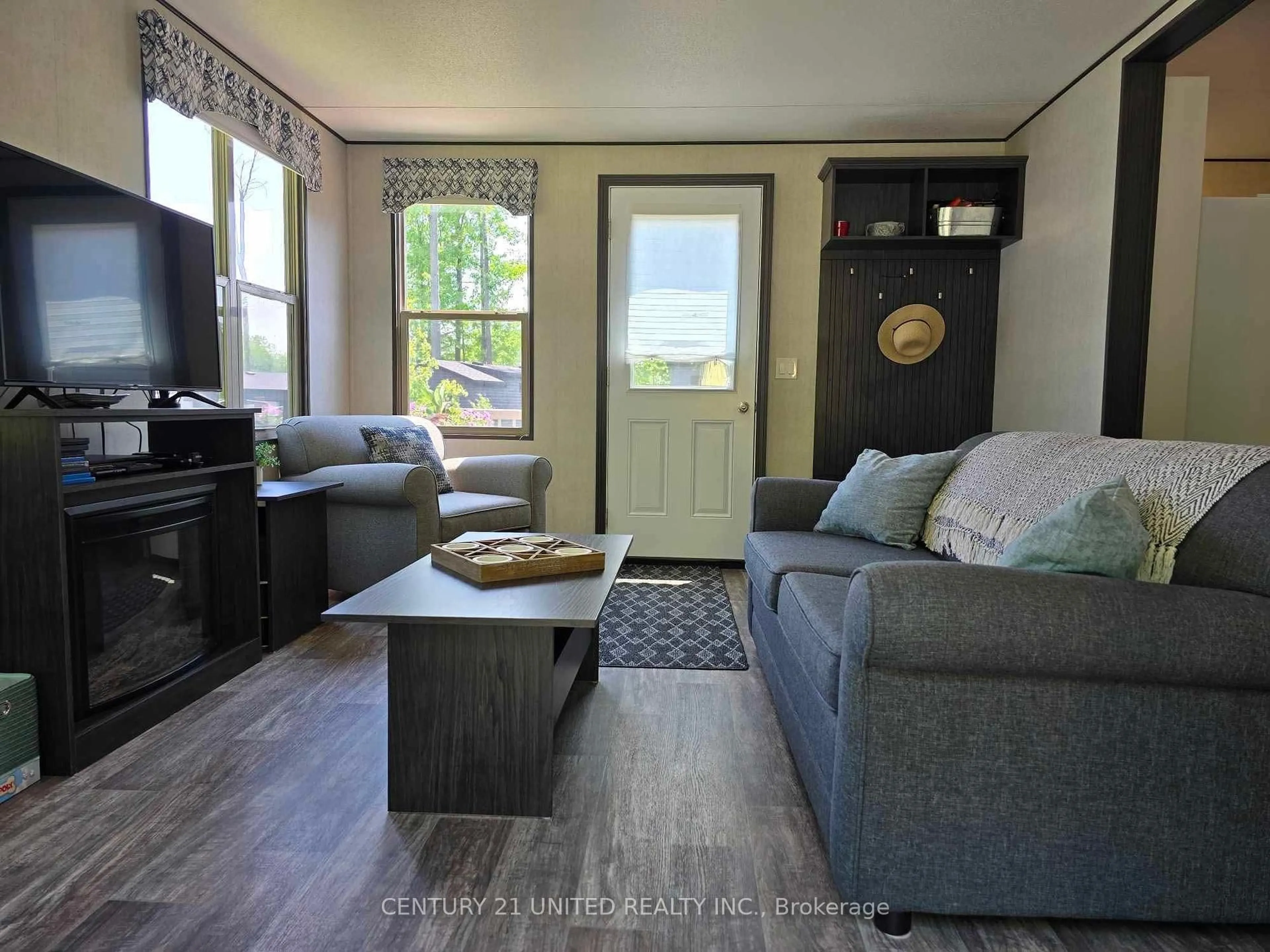 Living room with furniture, wood/laminate floor for 1235 Villiers Line #46, Otonabee-South Monaghan Ontario K0L 2G0