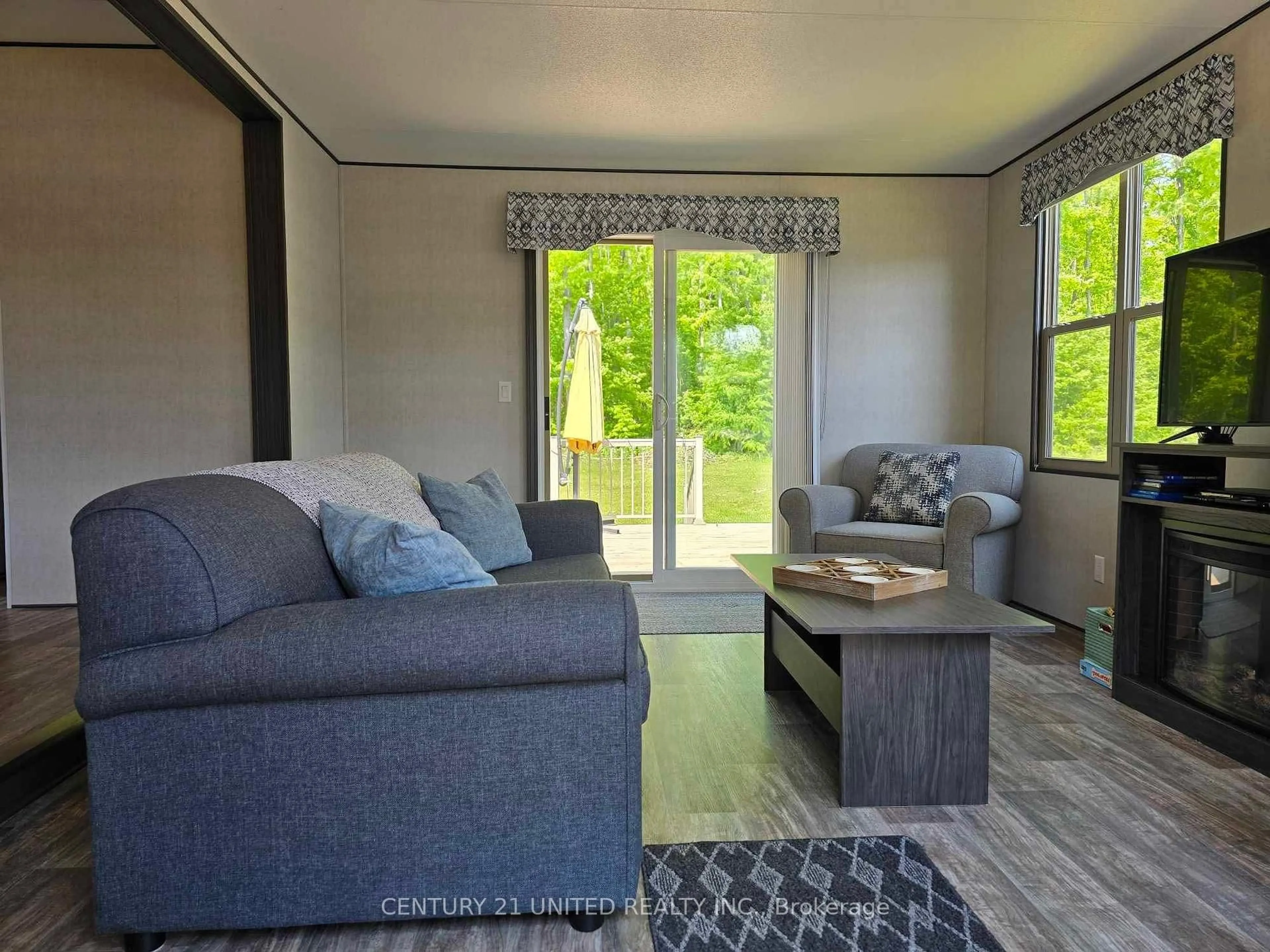 Living room with furniture, wood/laminate floor for 1235 Villiers Line #46, Otonabee-South Monaghan Ontario K0L 2G0