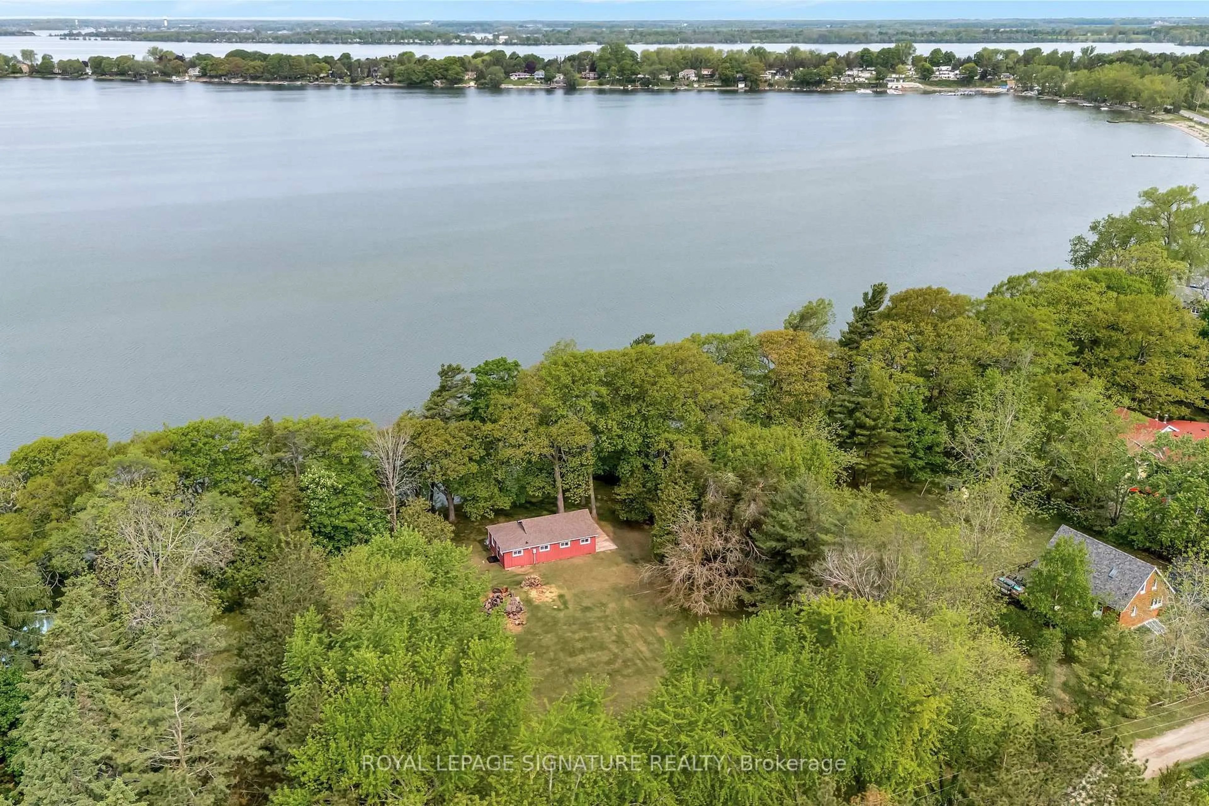 A pic from outside/outdoor area/front of a property/back of a property/a pic from drone, water/lake/river/ocean view for 27 Thrush Lane, Prince Edward County Ontario K0K 2T0