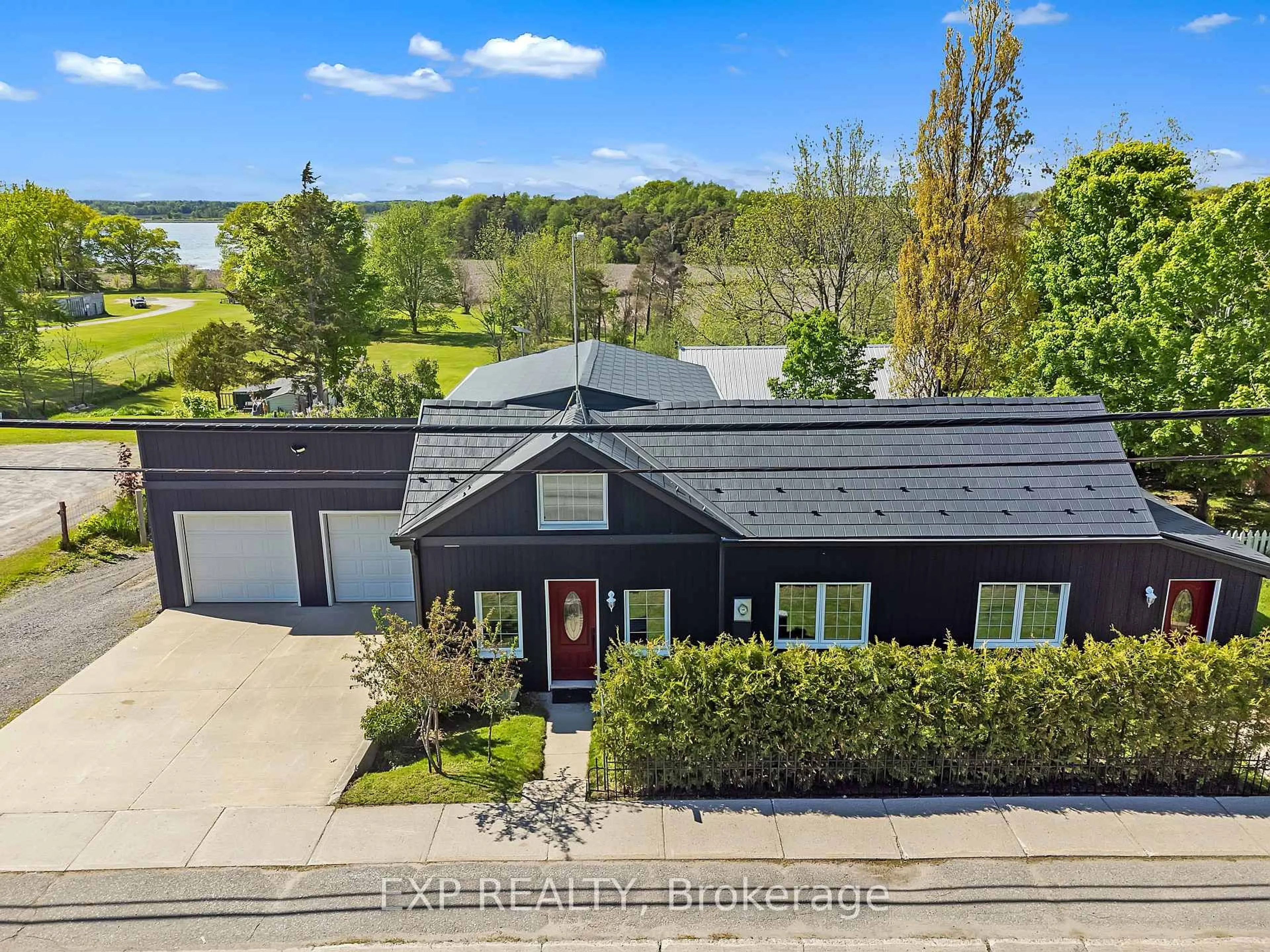 A pic from outside/outdoor area/front of a property/back of a property/a pic from drone, water/lake/river/ocean view for 1710 County Road 10, Prince Edward County Ontario K0K 1P0