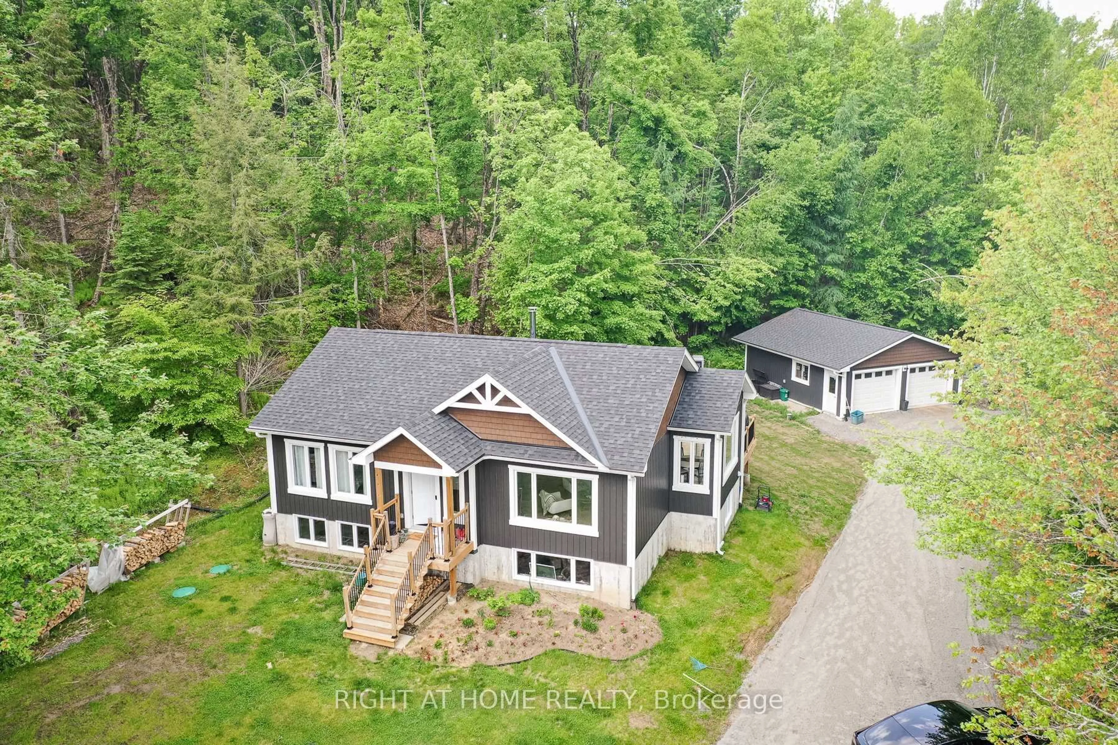 A pic from outside/outdoor area/front of a property/back of a property/a pic from drone, forest/trees view for 1087 Prospect Lake Rd, Bracebridge Ontario P1L 1X1