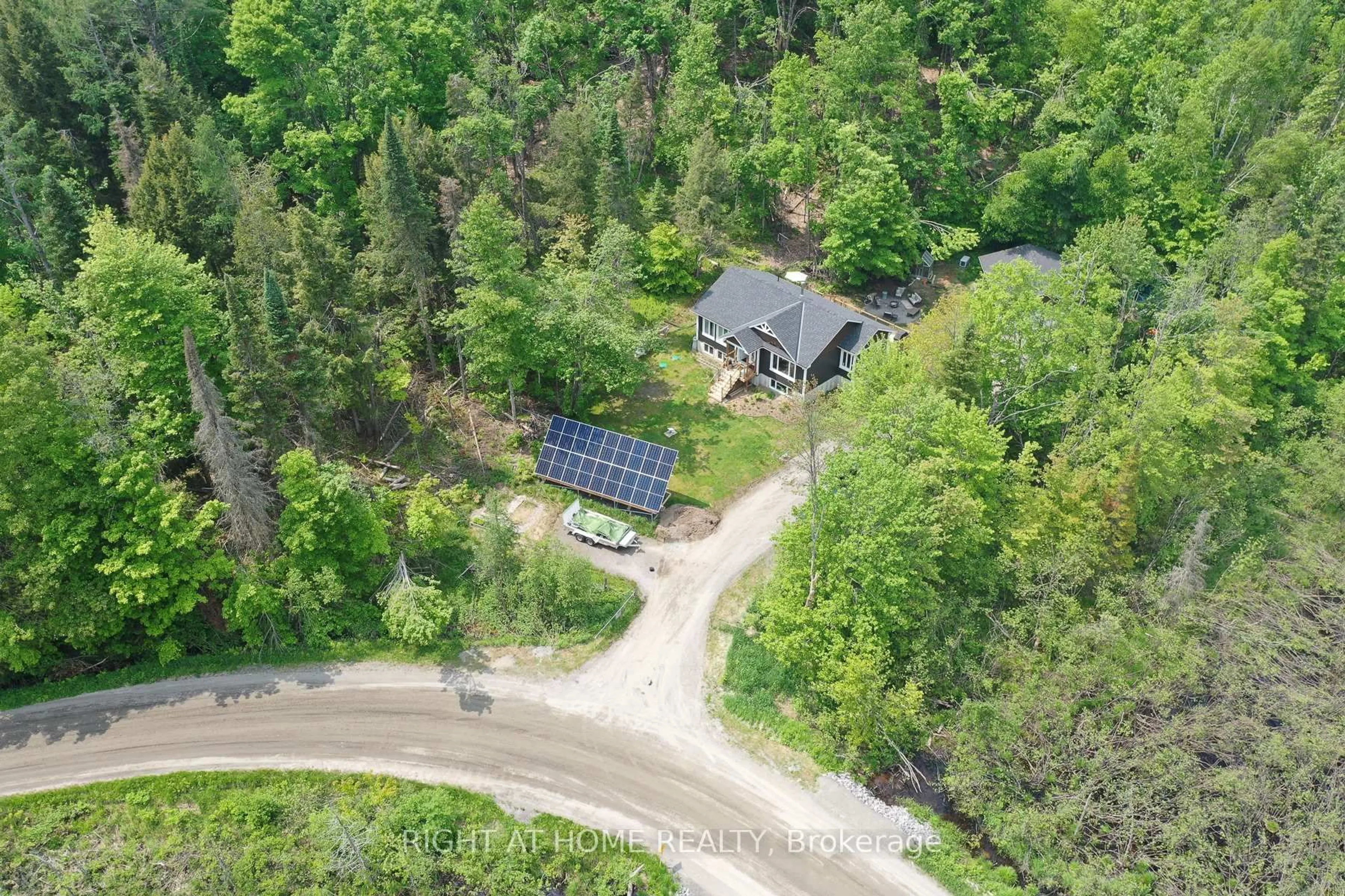 A pic from outside/outdoor area/front of a property/back of a property/a pic from drone, forest/trees view for 1087 Prospect Lake Rd, Bracebridge Ontario P1L 1X1