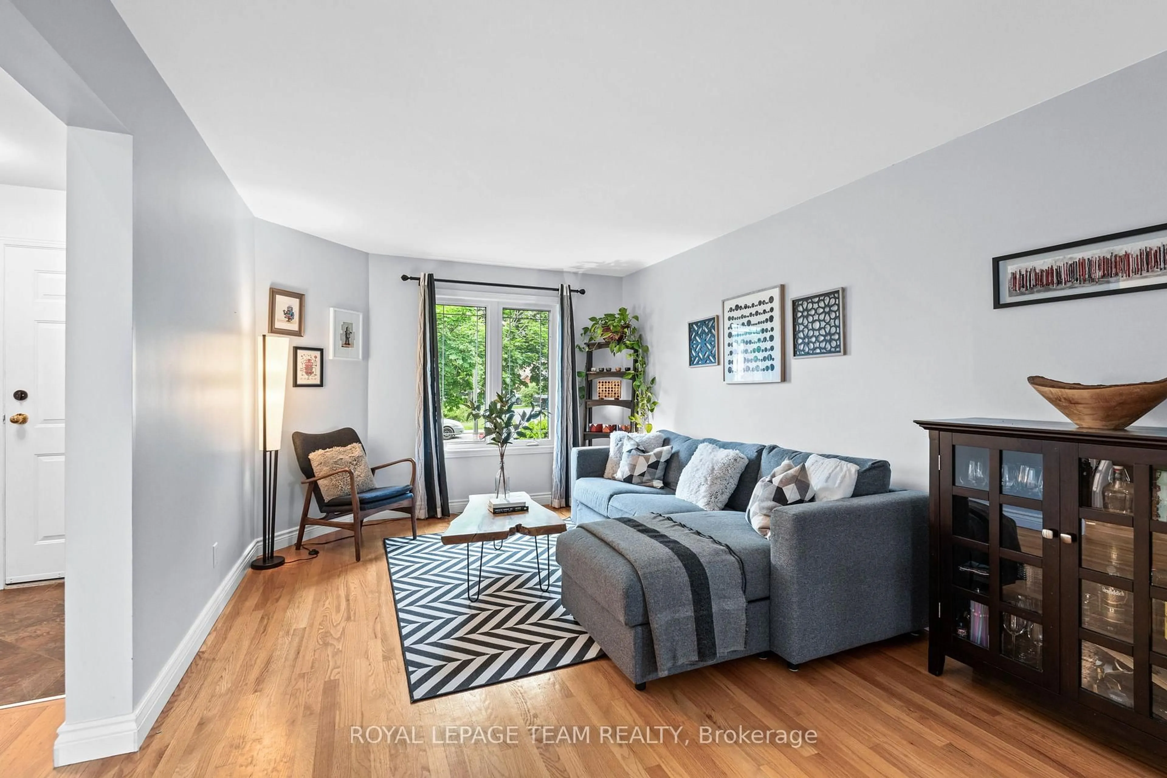 Living room with furniture, wood/laminate floor for 430 Pauline Charron Pl, Ottawa Ontario K1L 8L4