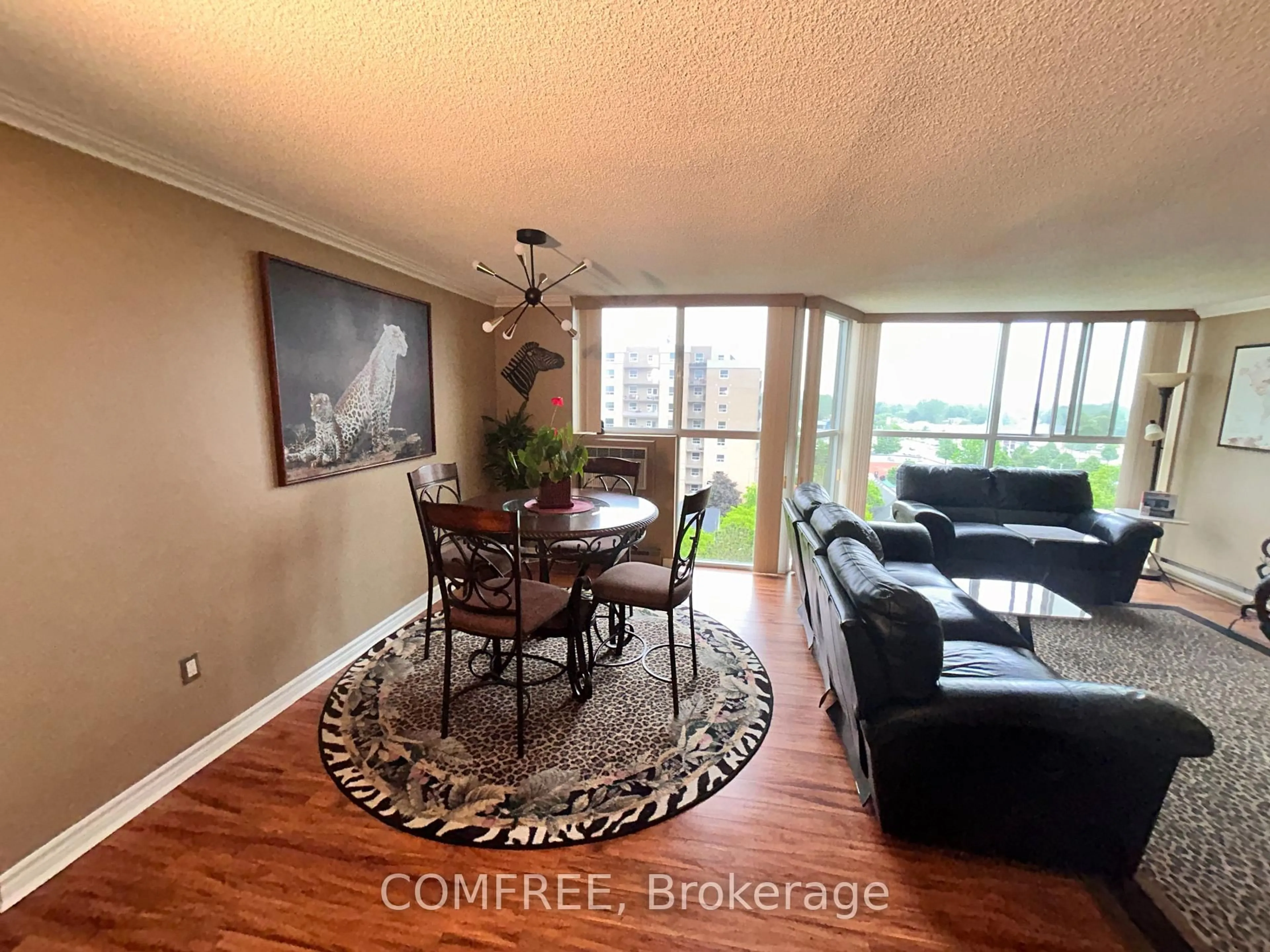 Living room with furniture, wood/laminate floor for 127 Belmont Dr #809, London South Ontario N6J 4J7