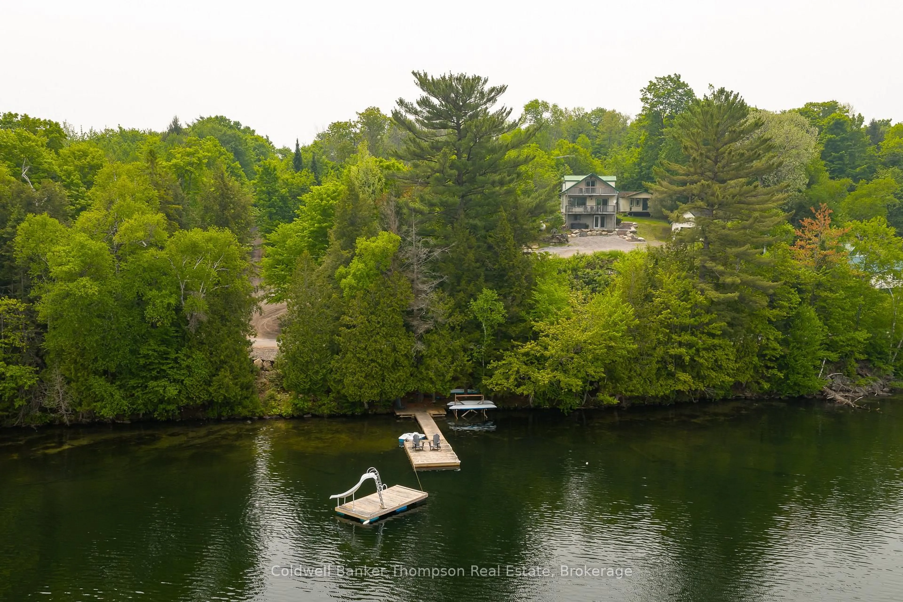 A pic from outside/outdoor area/front of a property/back of a property/a pic from drone, water/lake/river/ocean view for 879 Three Mile Lake Rd, Armour Ontario P0A 1L0