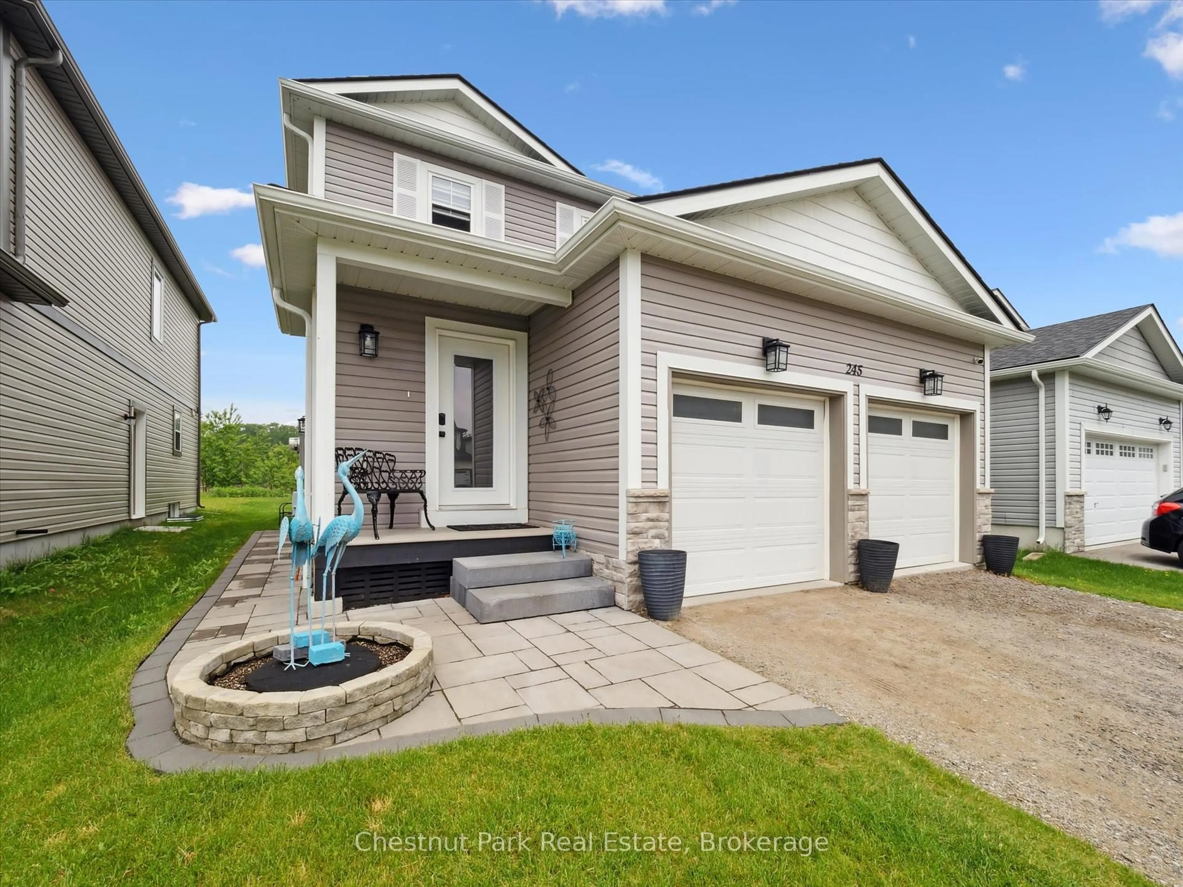Home with vinyl exterior material, street for 245 Wild Rose Dr, Gravenhurst Ontario P1P 0B4