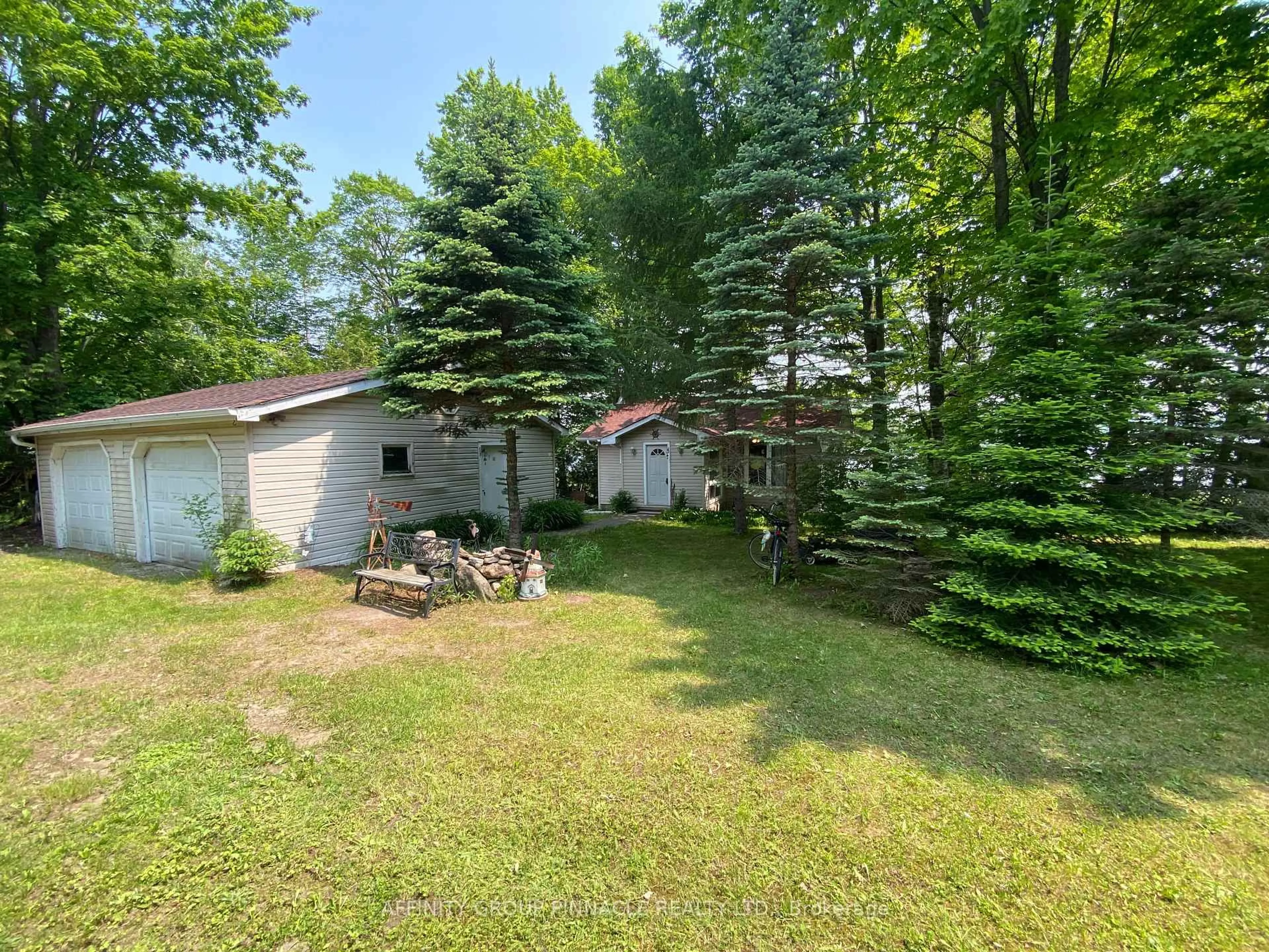 A pic from outside/outdoor area/front of a property/back of a property/a pic from drone, forest/trees view for 1314 Portage Rd, Kawartha Lakes Ontario K0M 2B0
