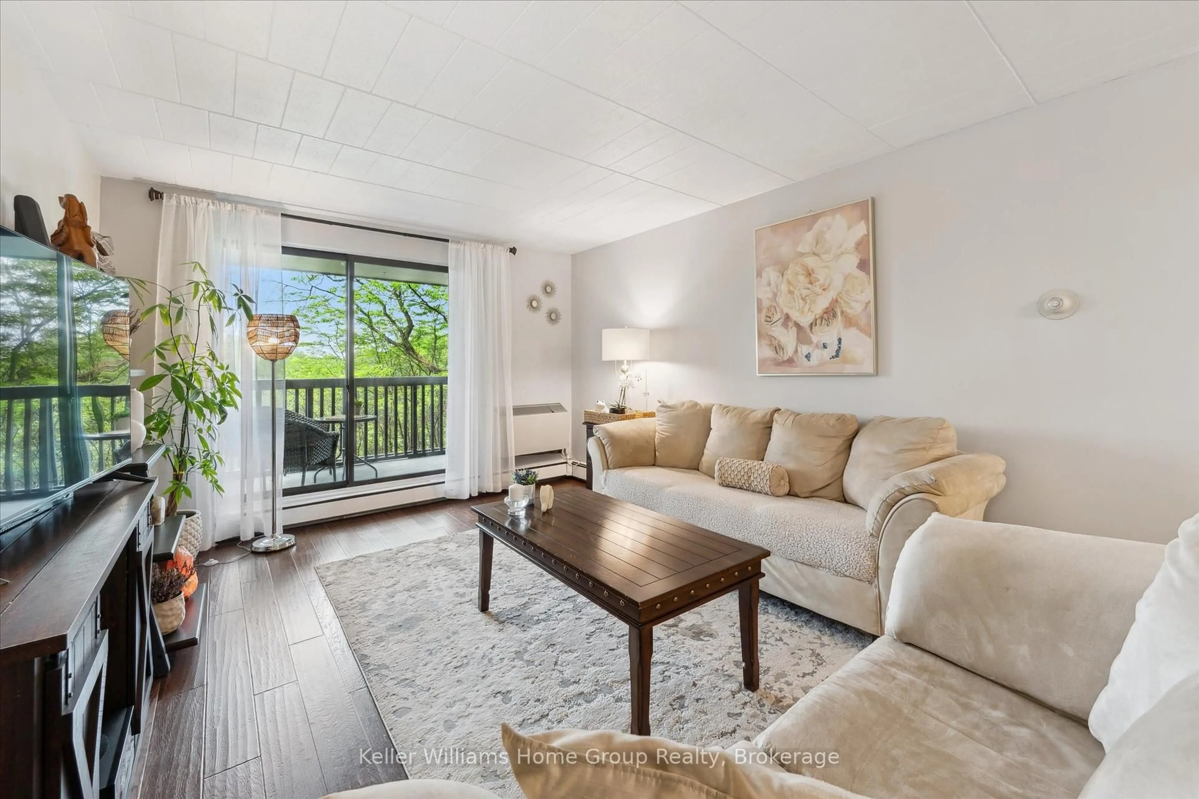 Living room with furniture, wood/laminate floor for 63 Conroy Cres #22, Guelph Ontario N1G 2V5