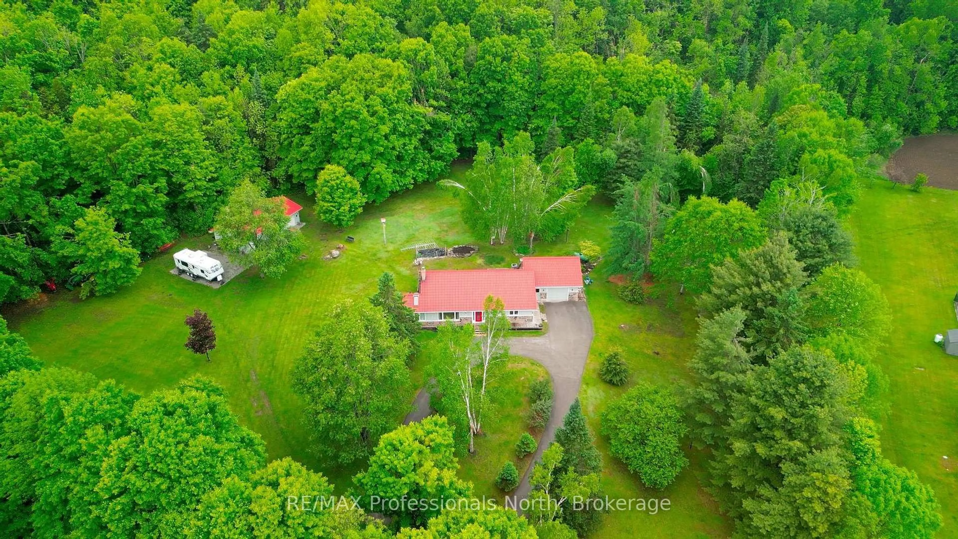 A pic from outside/outdoor area/front of a property/back of a property/a pic from drone, forest/trees view for 1006 Tennyson Rd, Minden Hills Ontario K0M 2K0