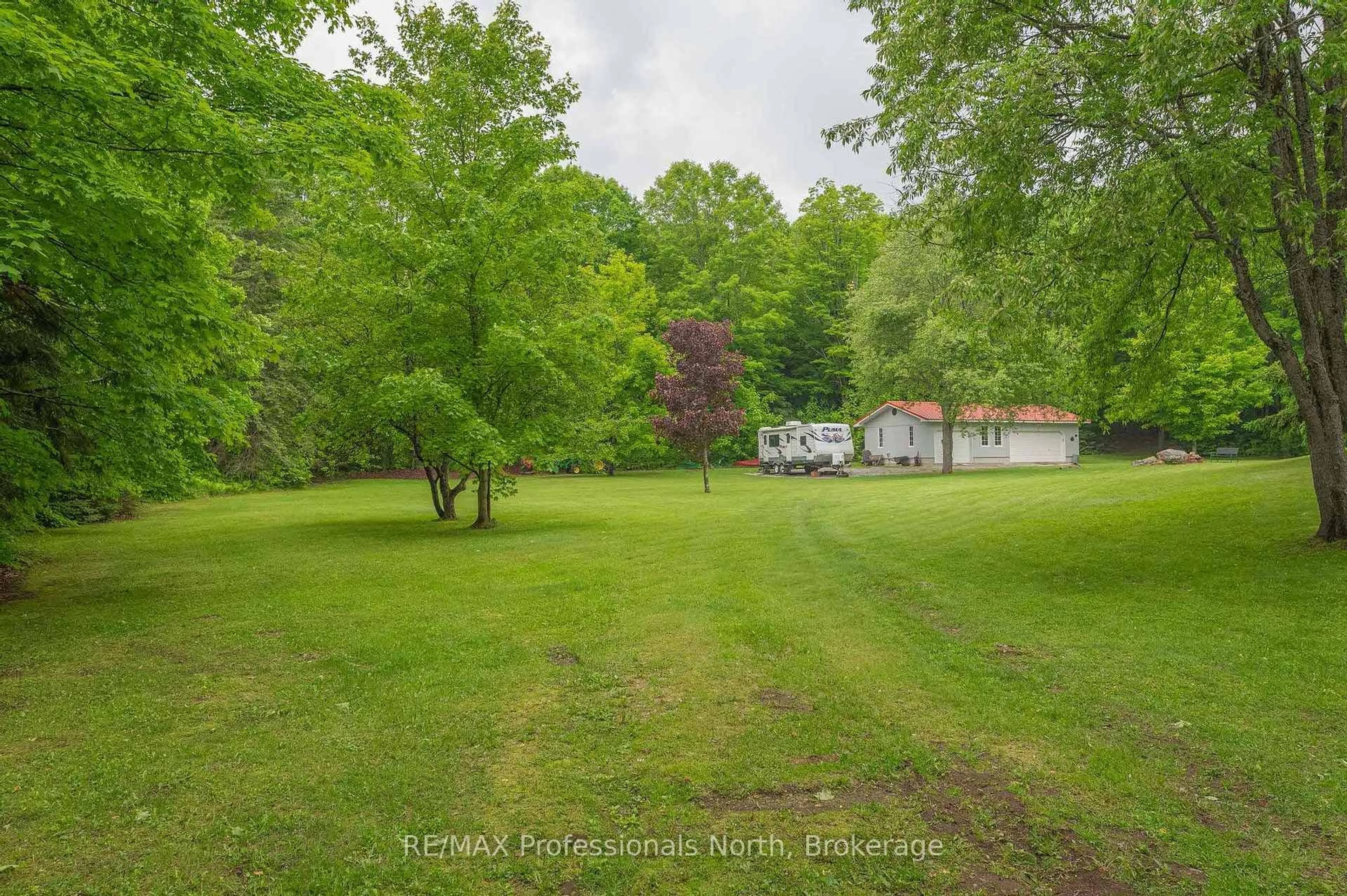 A pic from outside/outdoor area/front of a property/back of a property/a pic from drone, forest/trees view for 1006 Tennyson Rd, Minden Hills Ontario K0M 2K0