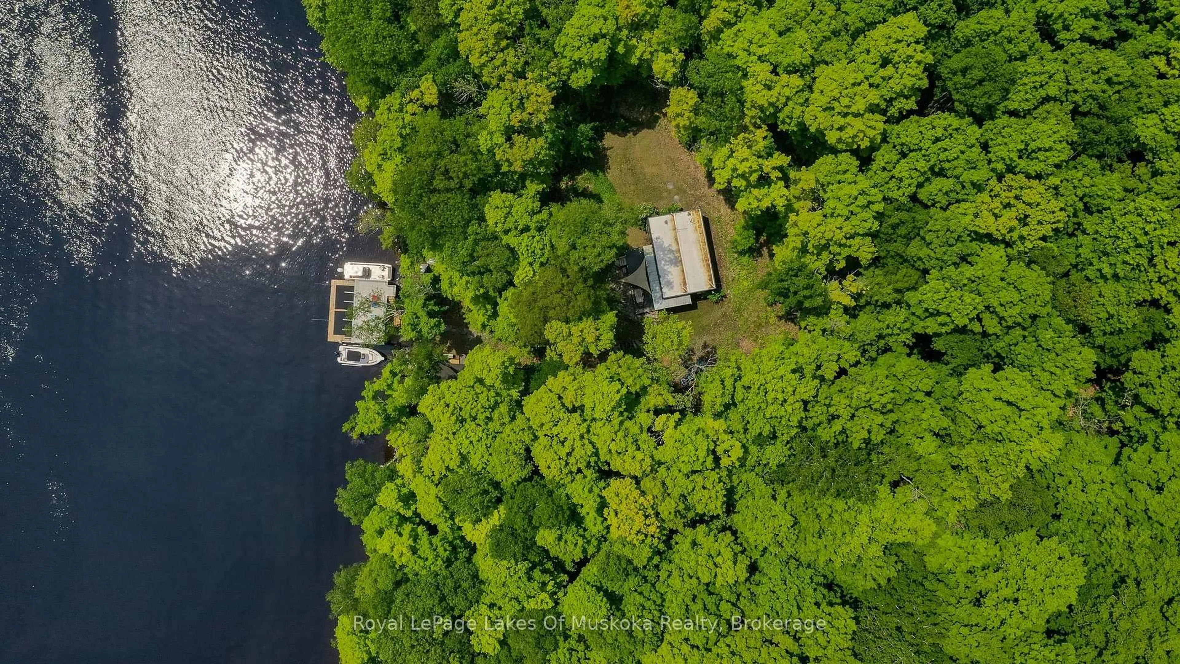 A pic from outside/outdoor area/front of a property/back of a property/a pic from drone, water/lake/river/ocean view for 484 Big Island, Huntsville Ontario P1H 2J3