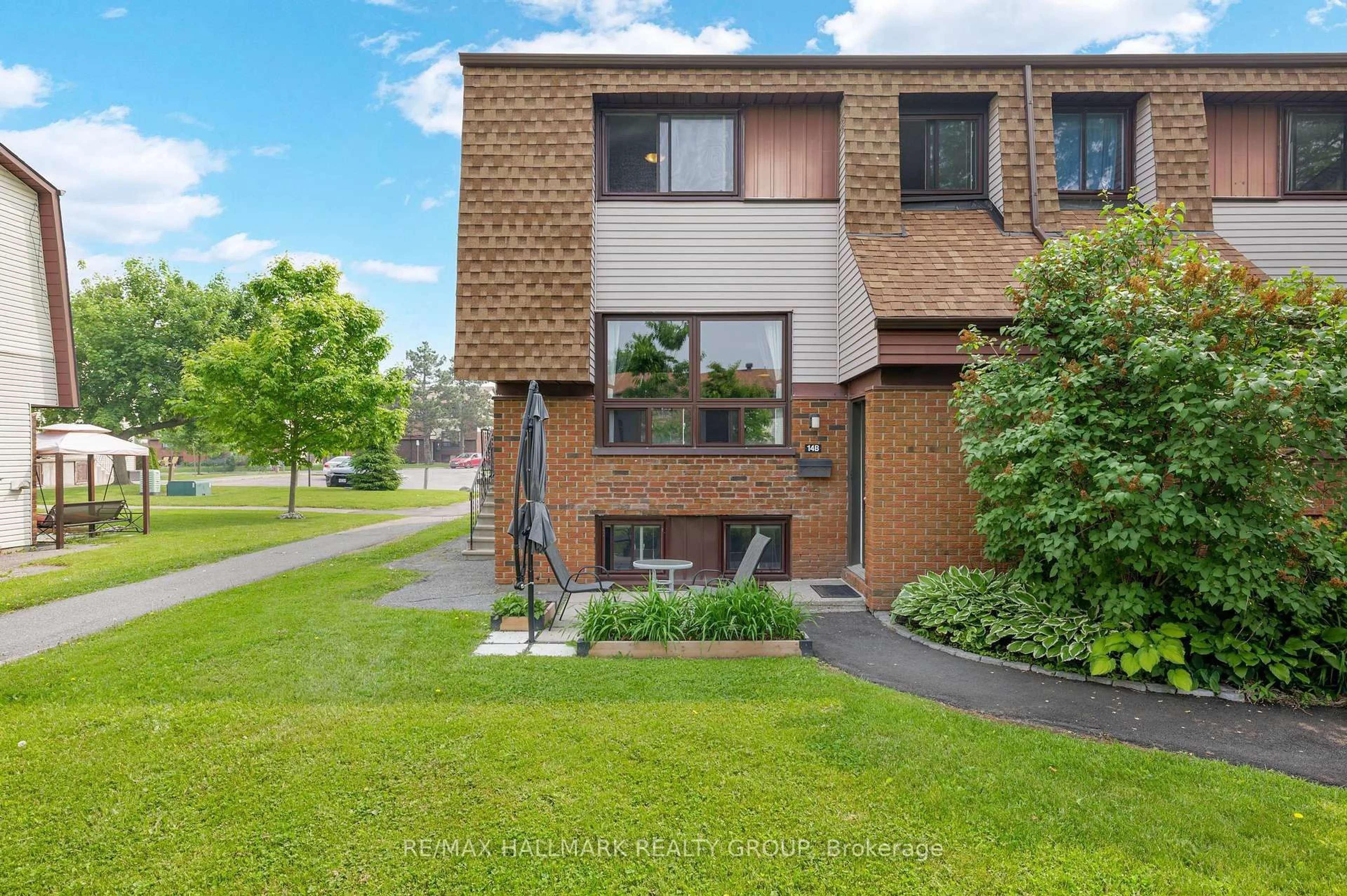 Home with brick exterior material, street for 14 Woodvale Green #B, Ottawa Ontario K2G 4G8